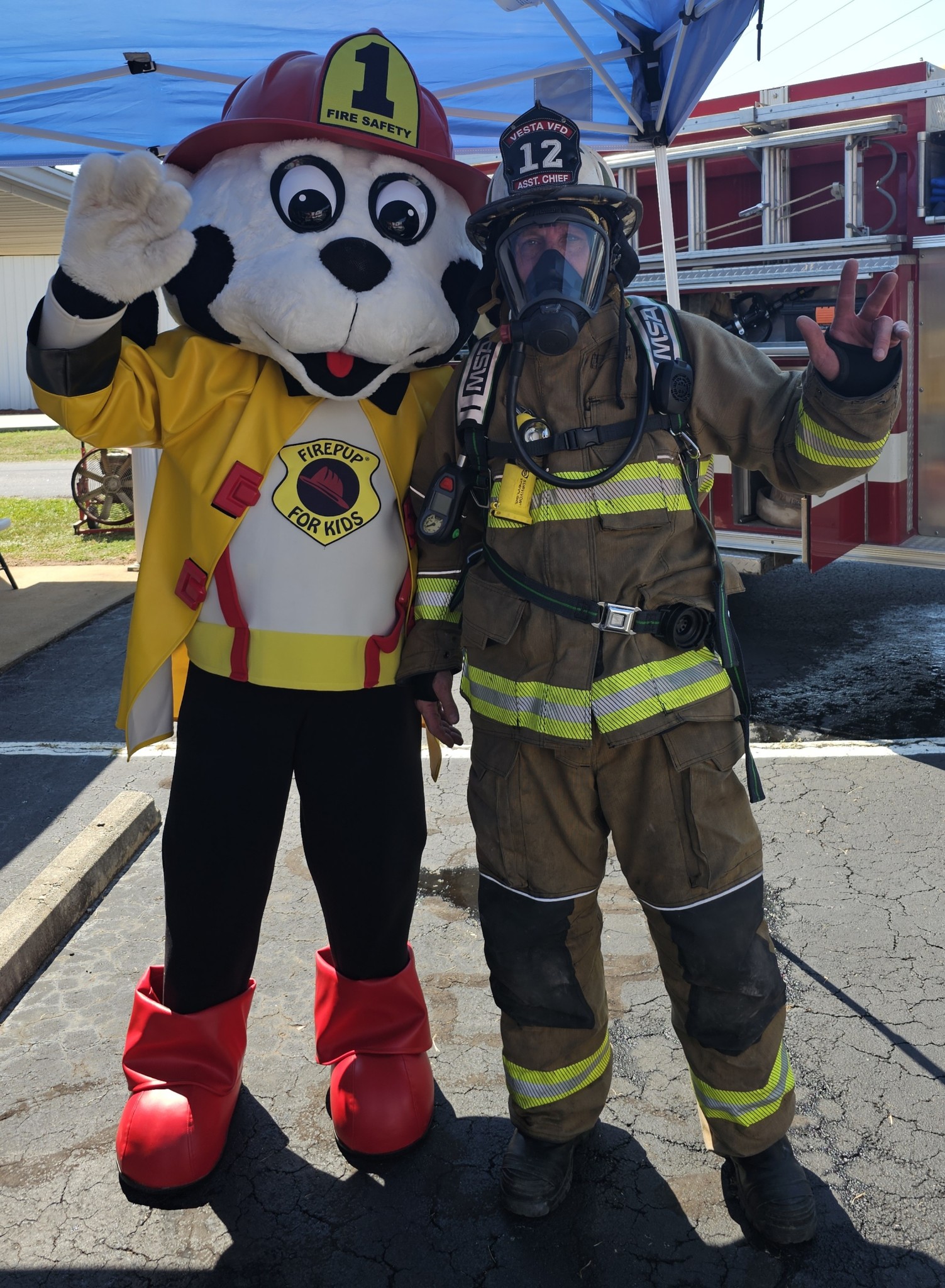 Assistant Fire Chief Michael Moravek Sr. poses with the station's mascot, Fire Pup. The station, comprised entirely of volunteers, is very involved in engaging the community as well as saving it. (Submitted Photo/Jennifer King)