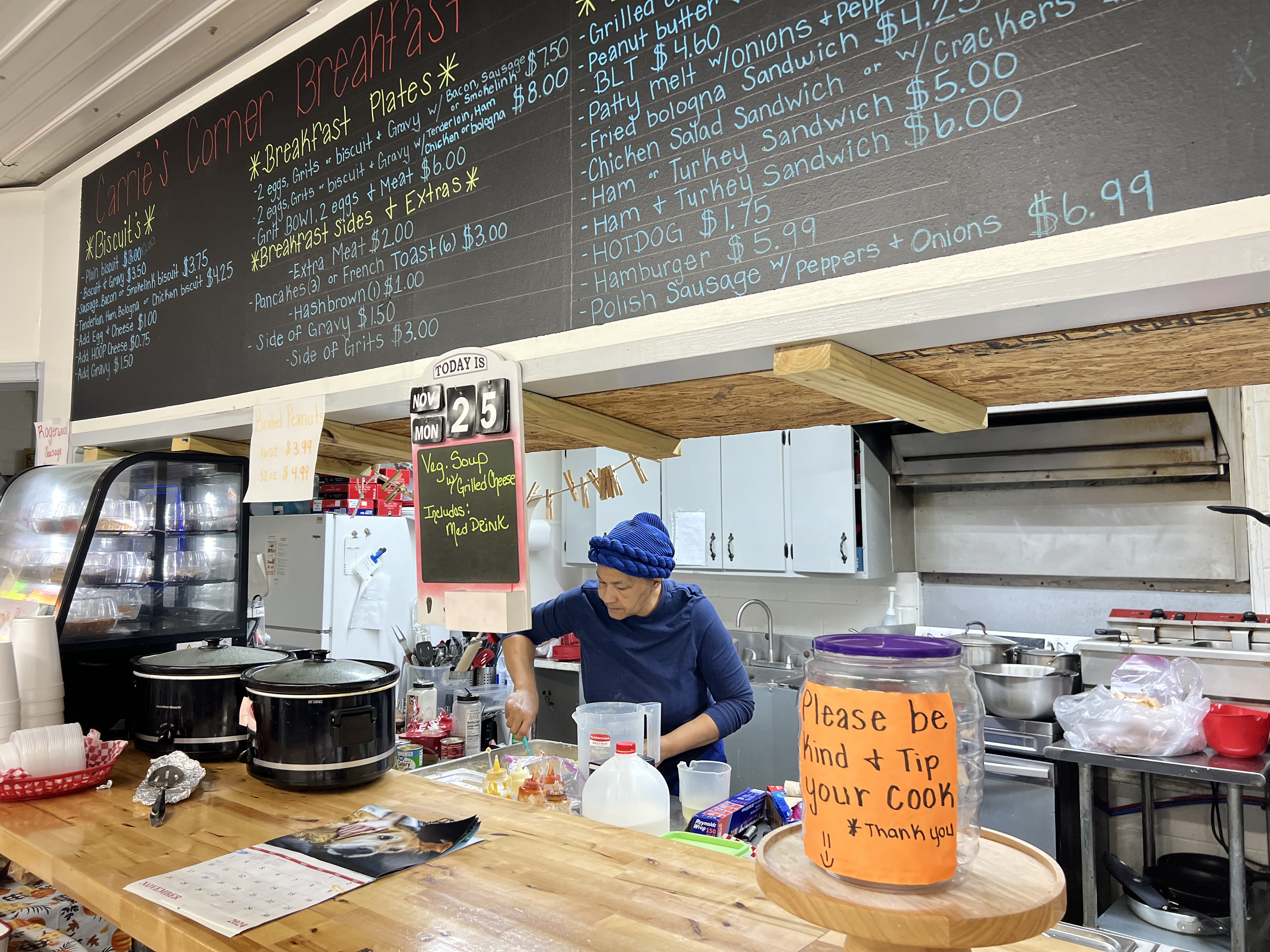 Chef Paulette Cade prepares food at Carrie's Corner Store & Cafe on Monday. Cade, who has worked at Carrie's for nearly two years, creates the menu of hot lunch specials each day. (Ella Kroll/The Oglethorpe Echo)