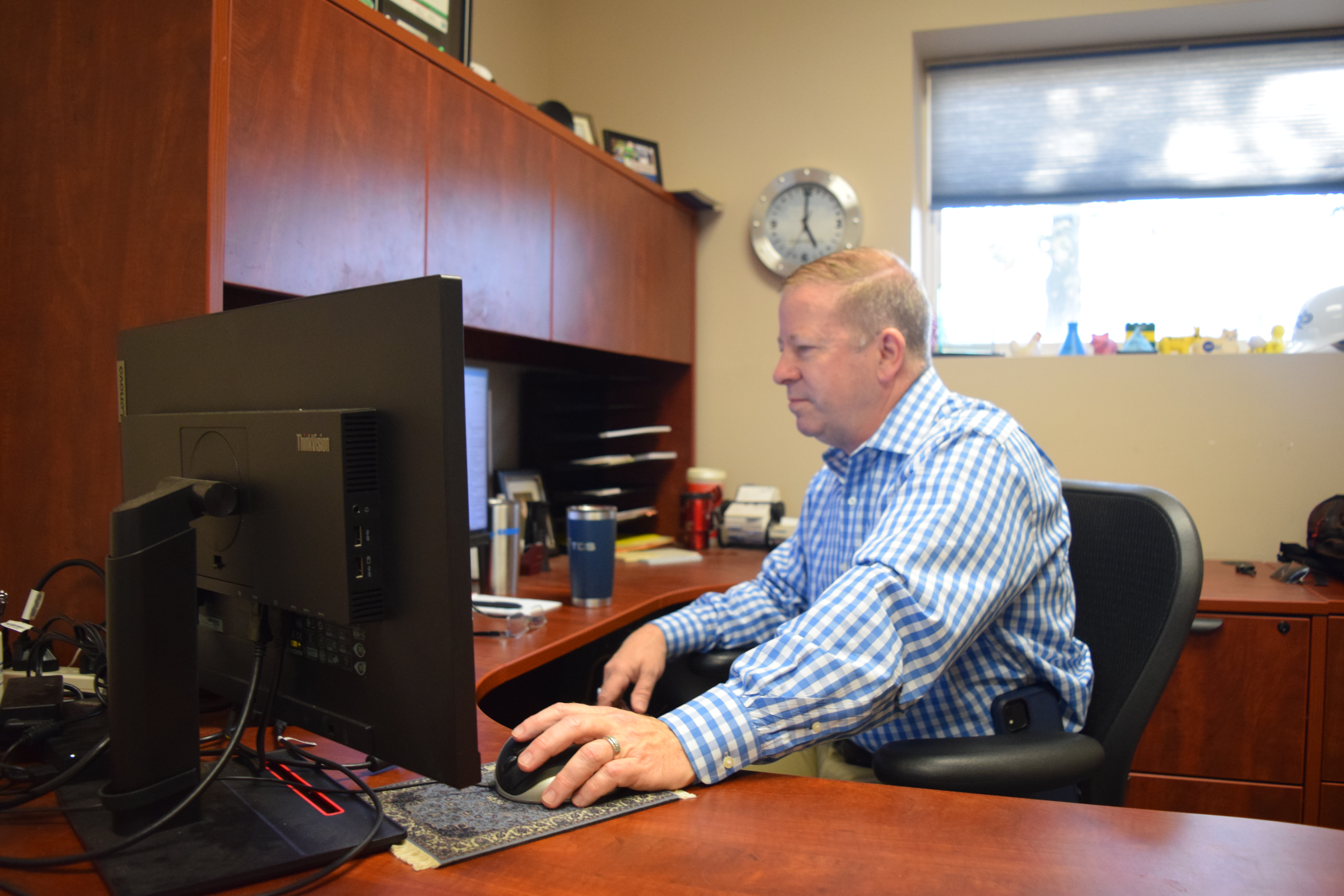 Tracy Norman, District 5 commissioner, responds to emails regarding the county in his office at  Boehringer Ingelheim in Athens, Ga. This is where Norman works full time when he is not serving Oglethorpe County.  On a slow day of being a board member, Norman might only do as much as respond to emails from residents. (Photo / Mary Catherine Dodys) 