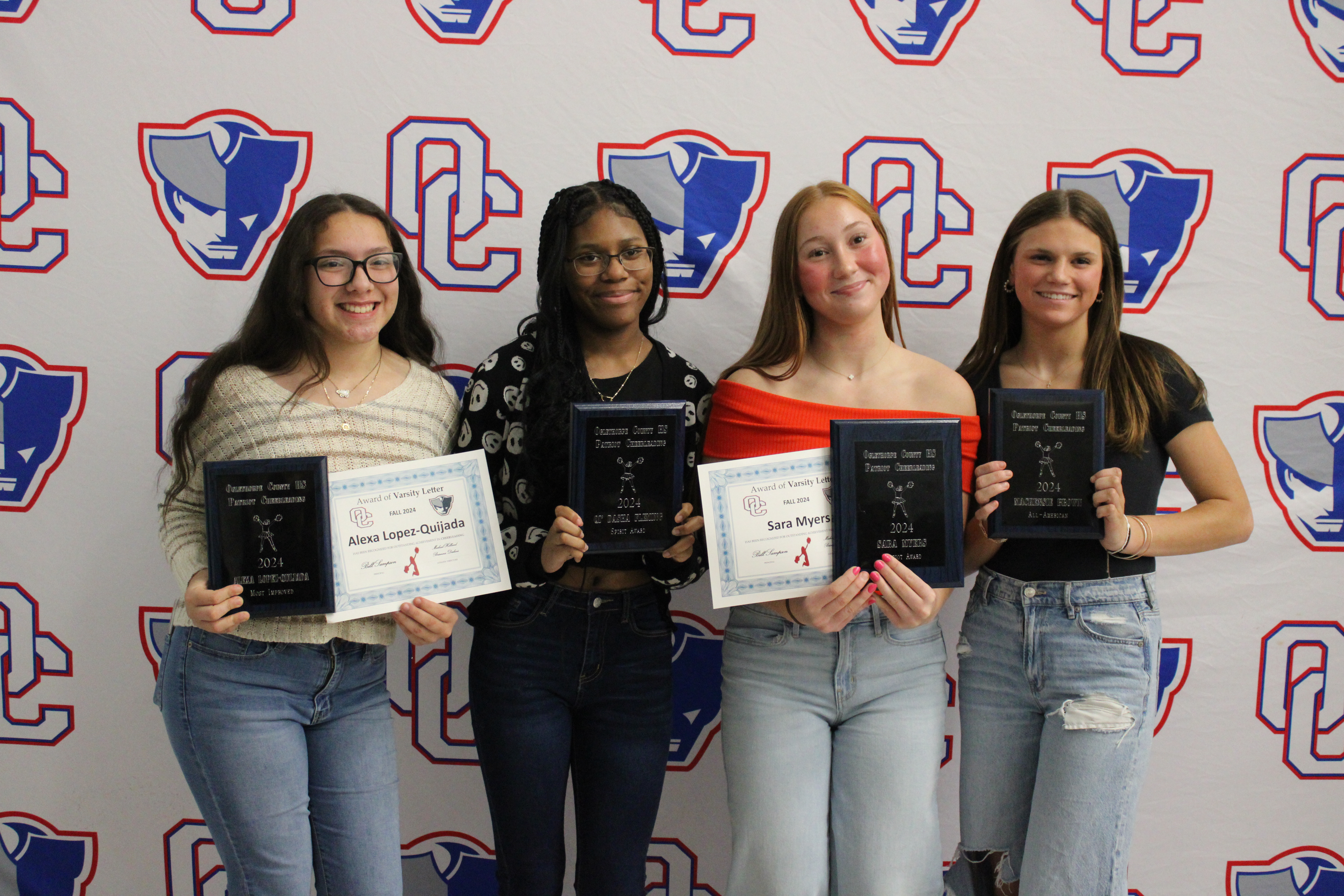 The cheer team award winners (from left): Alexa Lopez-Quijada (Most Improved), Qi’ Dasha Fleming (Spirit Award), Sara Myers (Patriot Award) and Mackensie Brown (All-American). (Audrey Pfitzner/The Oglethorpe Echo)