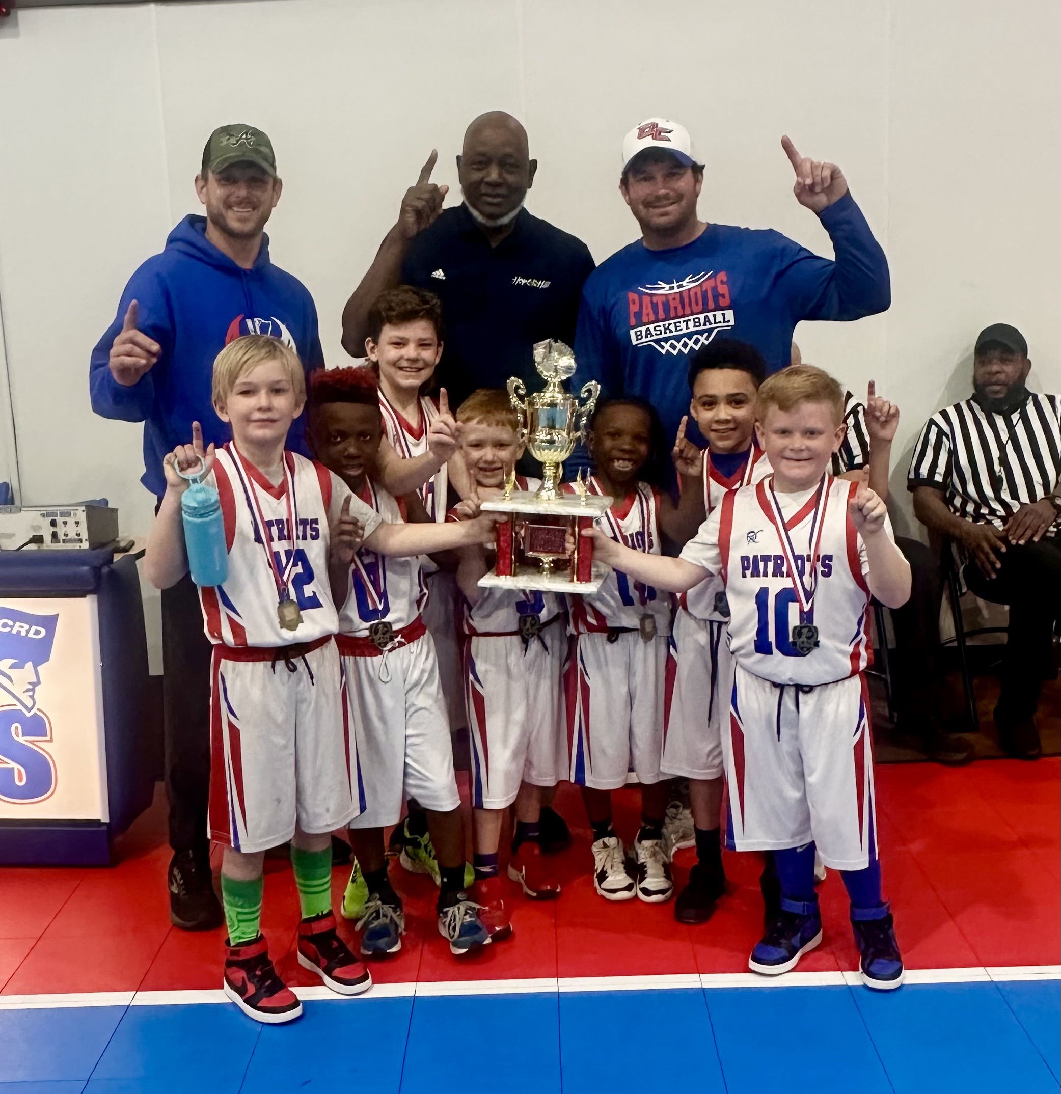 The 8u boys basketball team coached by Trae Lovin shows off the trophy after winning the championship on Jan. 18. The coaches include Dwight Howard, Shyanne Allgood and Lovin, and the team members are Tim Cheeseborough, Lane Allgood, Malachi Smith, John Kade Lovin, Max Mathews, Jordan Turner and Chase Turner. (Submitted photo)