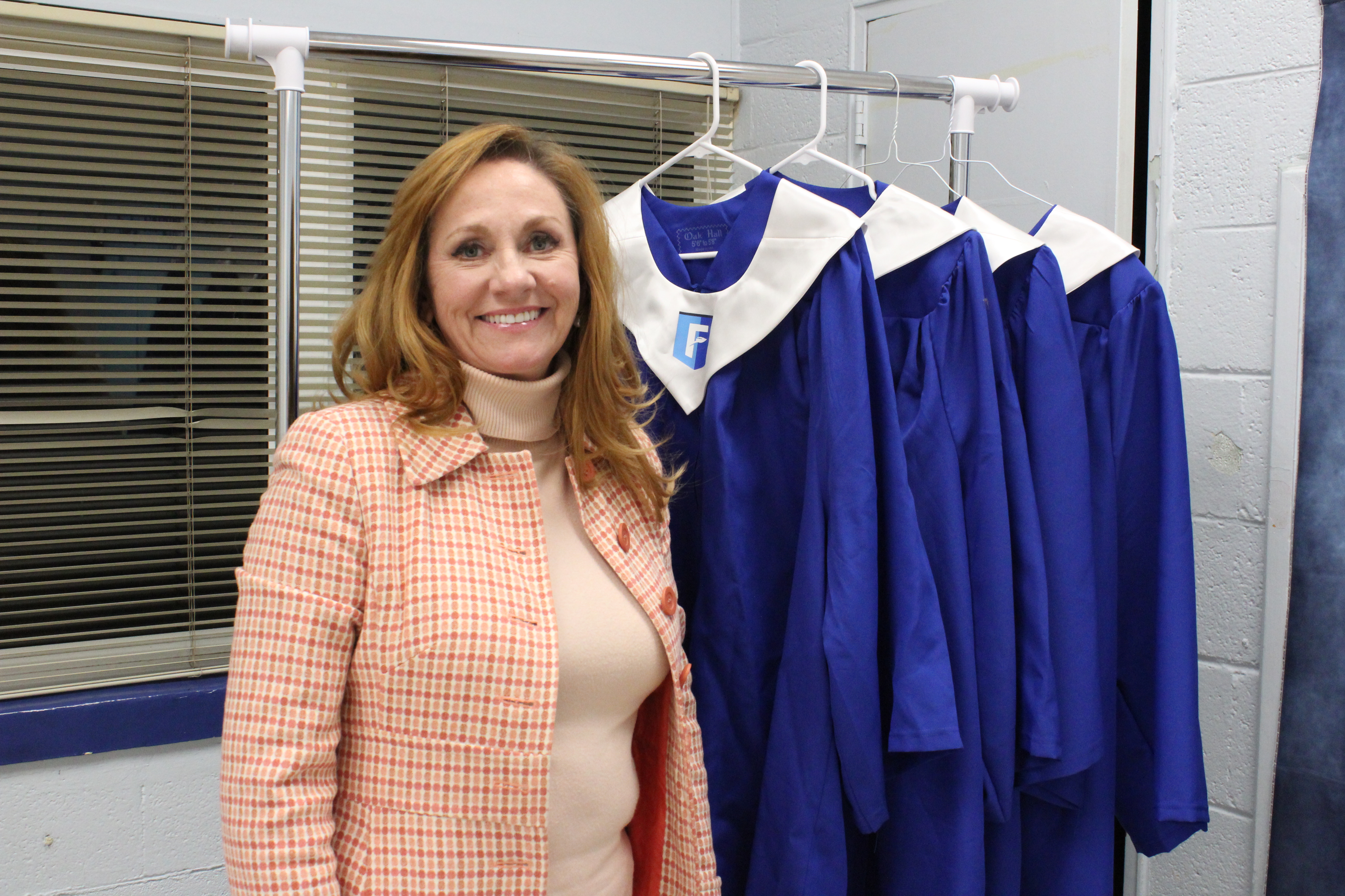 Renee McCannon, a mentor at the Oglethorpe County Foothills, poses with graduation robes. McCannon also is a mentor coordinator and REACH scholarship coordinator for Madison County Schools. (Bridget Goodman/The Oglethorpe Echo)
