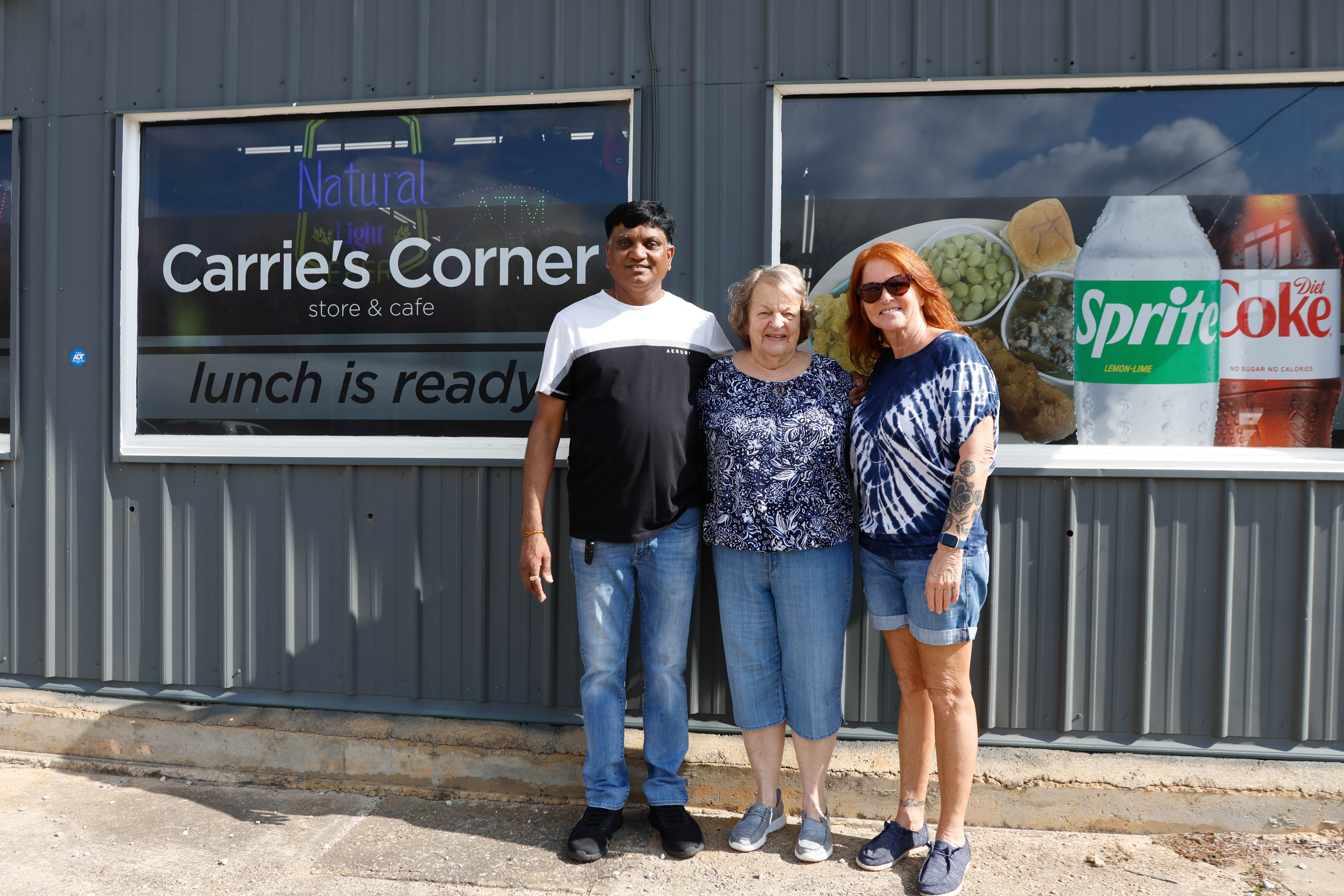 (Left - Right) Jay Patel, Beulah Hatchett (Nana) and Carrie Faris pose for a photo at Carrie’s Corner Store & Cafe in Stephens, Georgia on Friday, Feb. 7, 2025. Faris sold the business to Patel at the end of January. (Photo/Libby Hobbs)