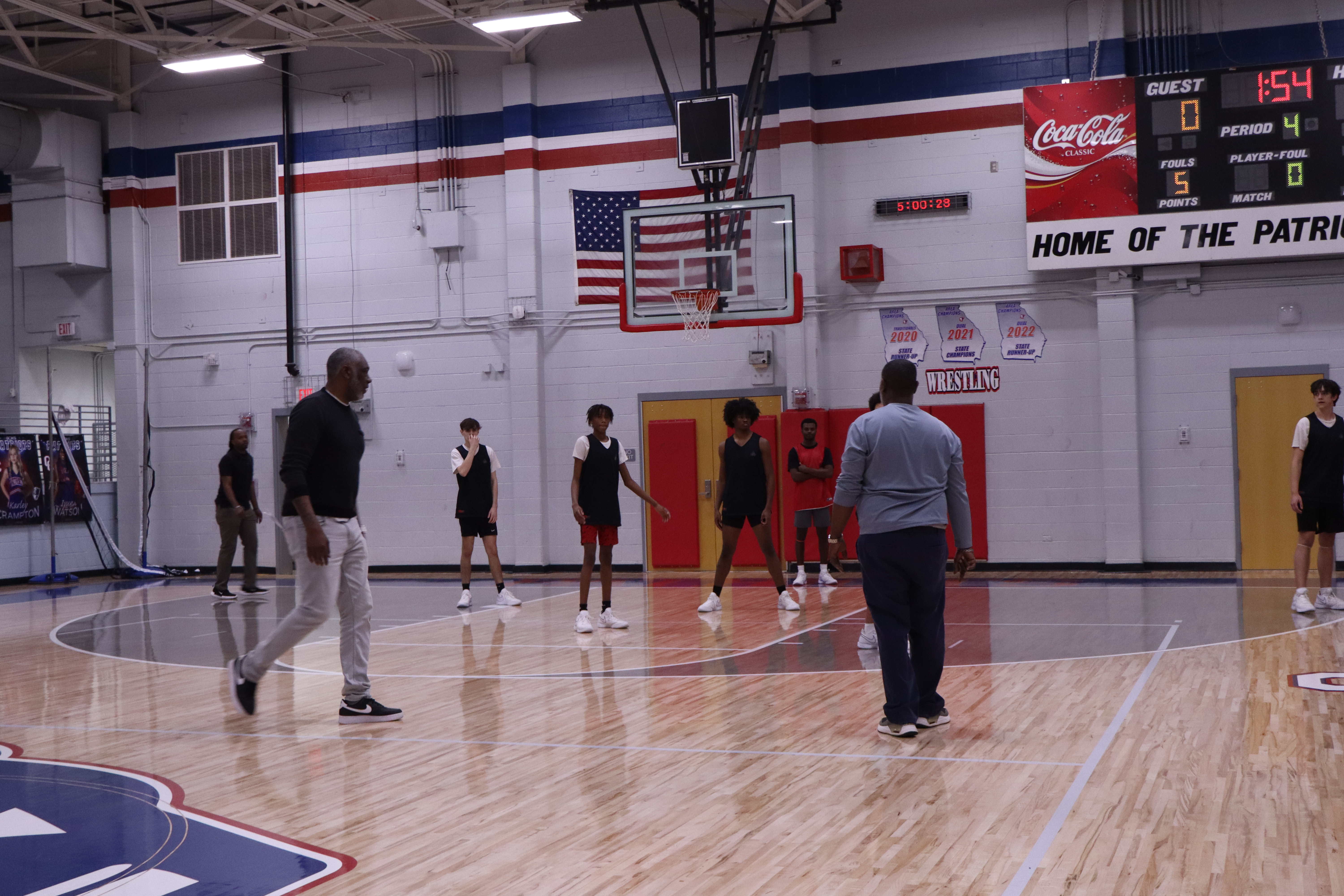 OCHS boys basketball coach Carlos Strong (left) and his coaching staff run drills at practice last month. This was the first season as coach of the Patriots for Strong, a former Cedar Shoals and UGA basketball star, who played in the NBA. (Avery Cameron/The Oglethorpe Echo)