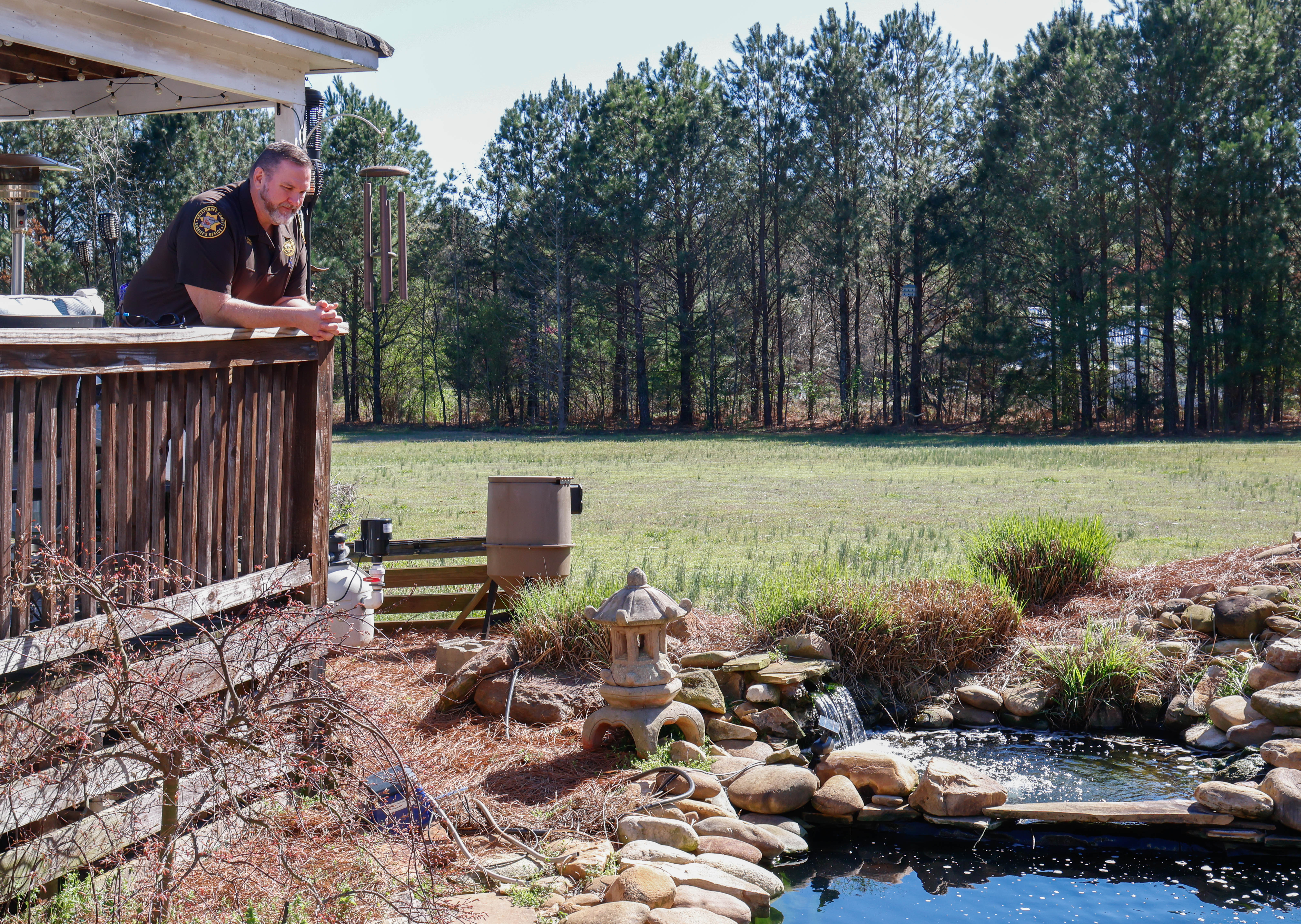 Sheriff David Gabriel stares out over the lower pond within his backyard in Winterville, Georgia on Monday, March 17, 2025. For someone with such a high-stress occupation, a relaxing environment to come home to is essential. “Listen to the water, breeze blowing. The breeze always blows here, you know. Sit there and watch the fish, you know. Just watch them move around the water. It's just natural, you know,” Gabriel said. (Photo/Felix Scheyer)