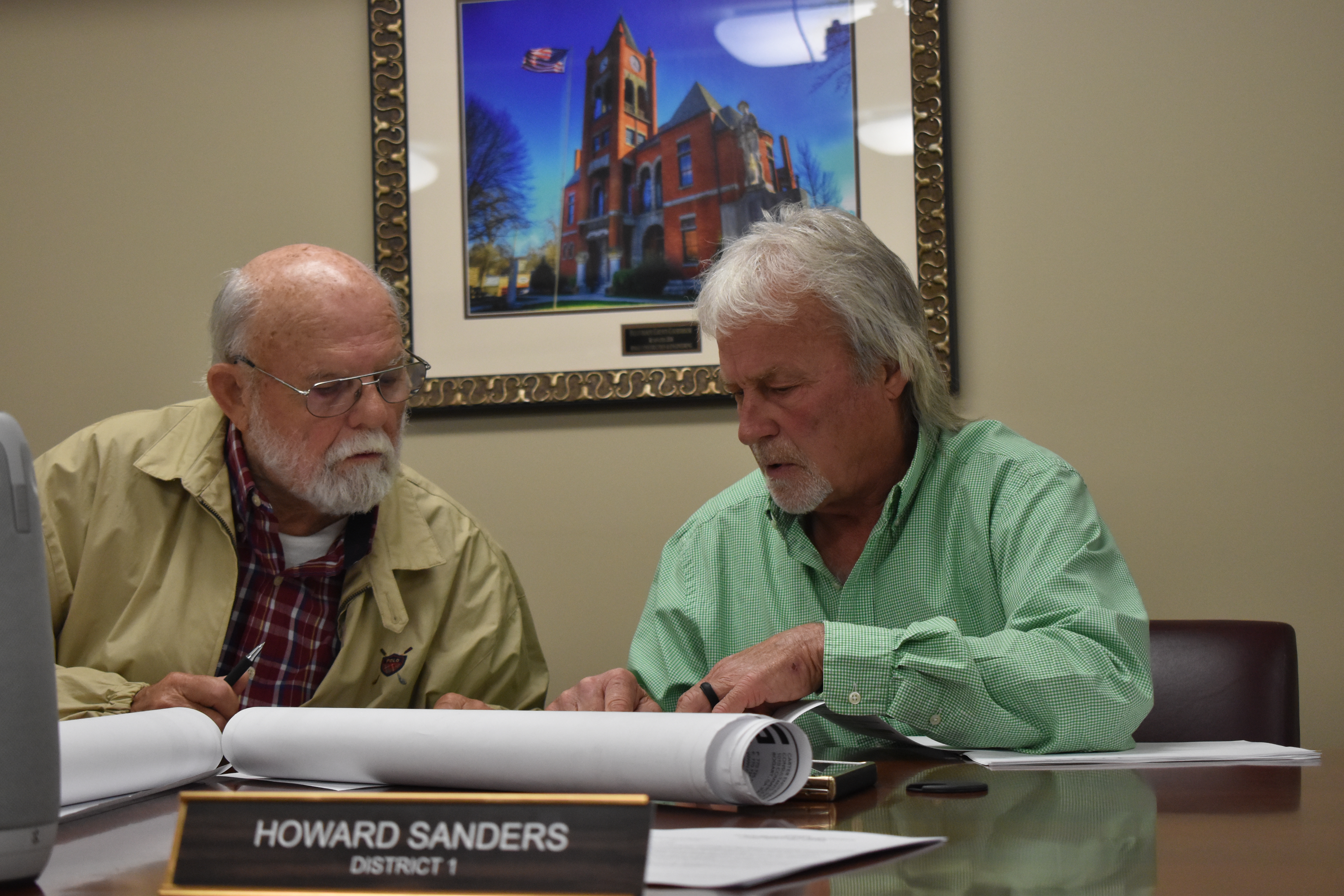 District 1 Commissioners Howard Sanders (right) and District 3 Commissioner David Clark (left) examine a map of Dredrick Lane's property has he defended his variance request at the April Board of Commissioners meeting on April 7, 2025, in Lexington, Georgia. Lane was granted his request for an address on Hutchins Wolfskin Road. (Photo/Zach Leggio)