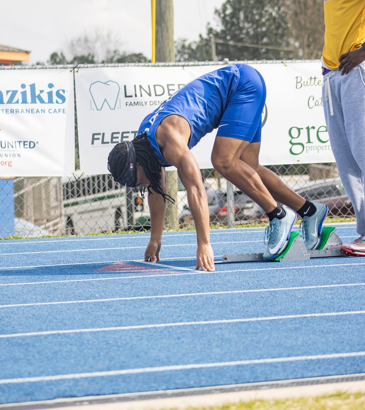 OCHS senior Jordan Johnson prepares to take off at a track meet. Johnson runs in the 100 meter dash, the 200 meter dash, and legs of the 4x100 and 4x200 relays. (Submitted photo)