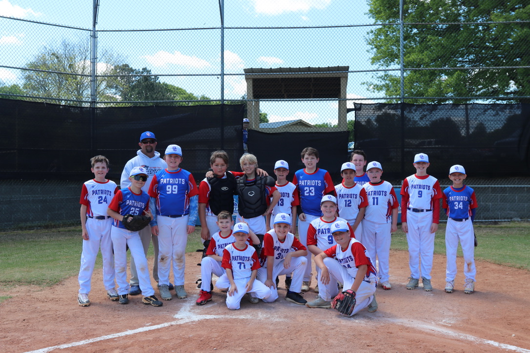 Coach Michael White and the combined Major League teams stand on home plate following the home team's 7-1 win on April 12. White said he was the only coach present at the game because of the rainouts on March 10. (Photo/Anna Izquierdo)