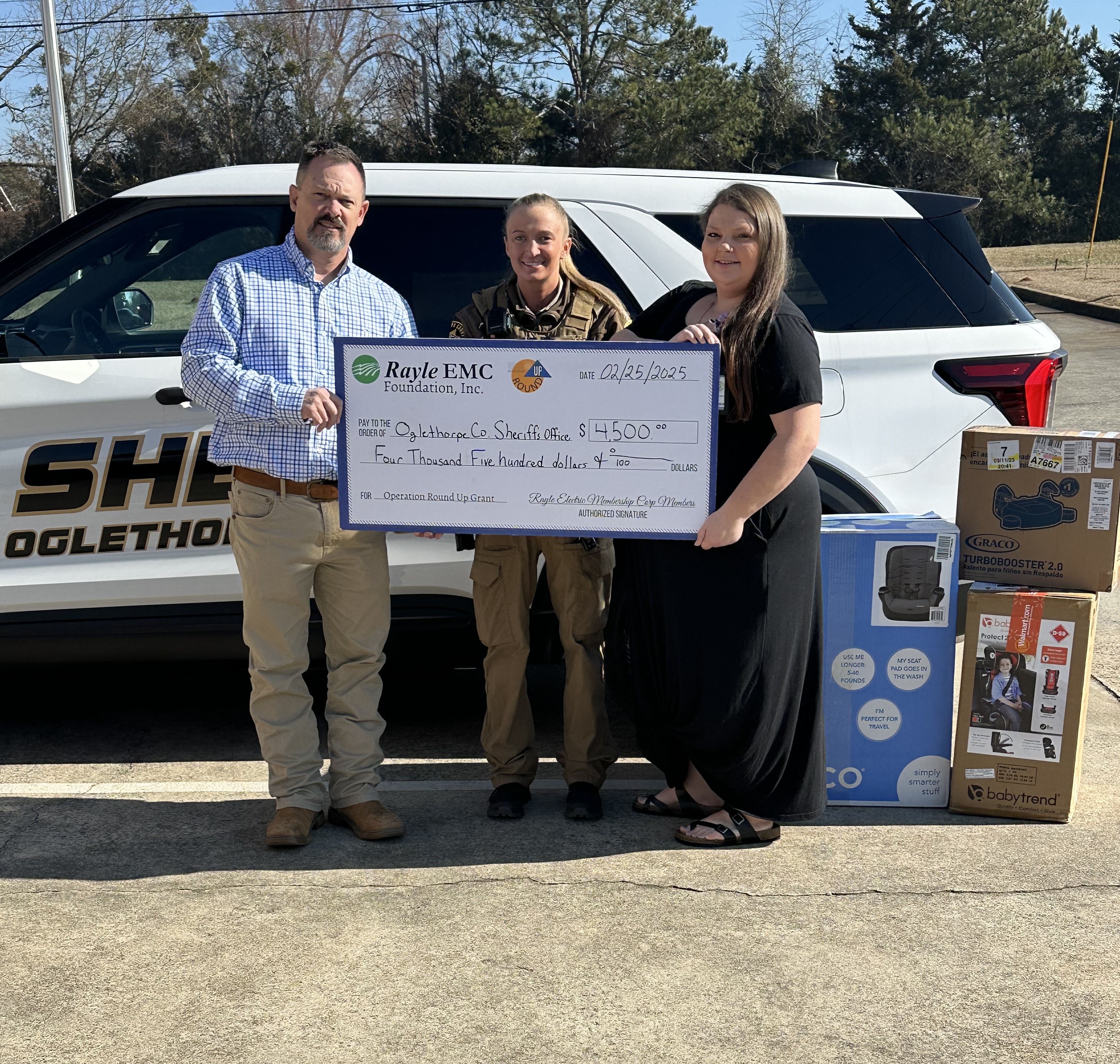 Rayle EMC’s Richard Heard (left) presents a check to the Oglethorpe County Sheriff’s Office’s Courtney Corbin and Shae Peek for a car seat program. The money was used to purchase car seats for county residents. (Submitted Photo)
