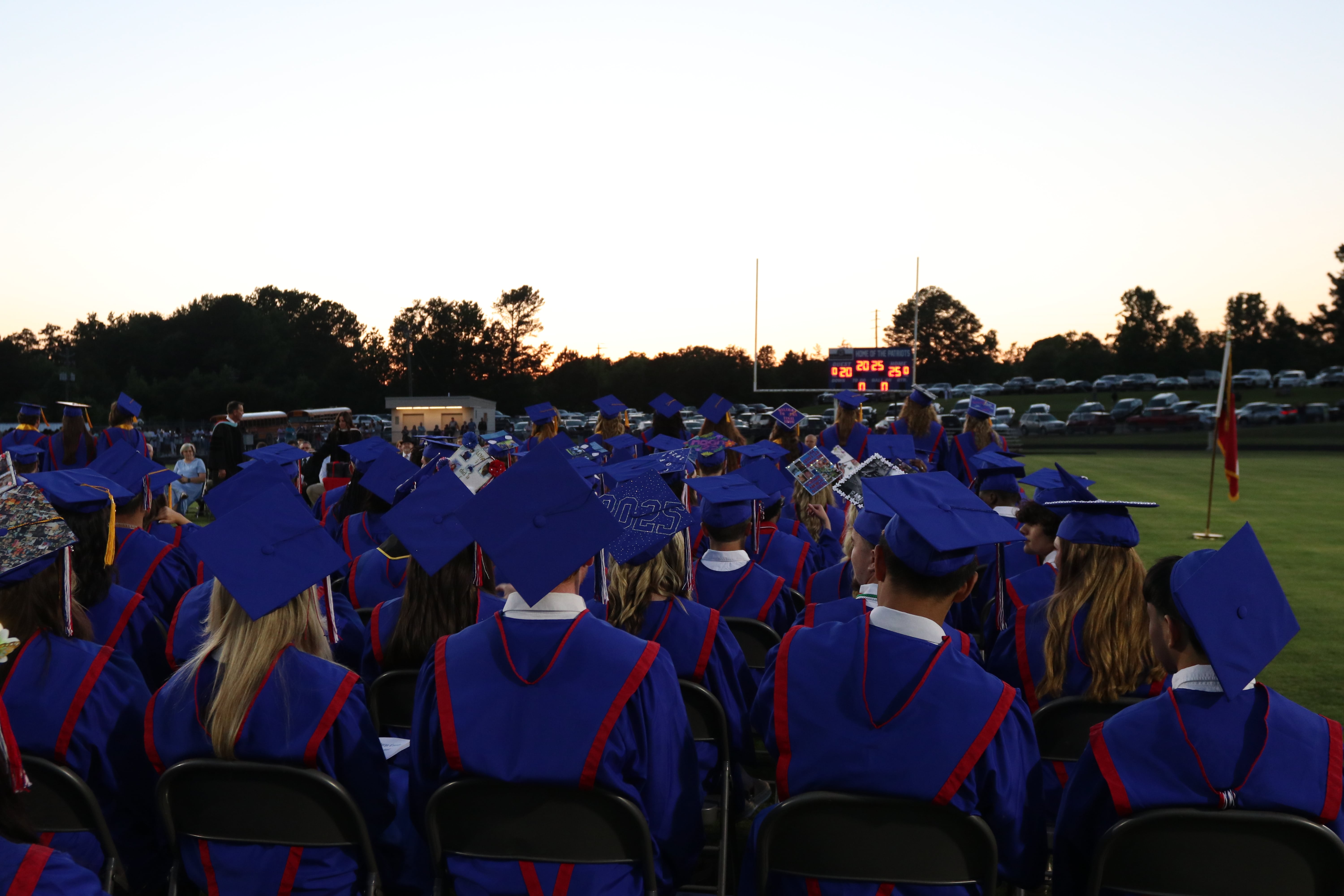 Graduates adorned in blue caps and gowns sit in chairs on the field last Friday before the OCHS graduation ceremony began. Principal Bill Sampson gave the opening speech, reminding students to be kind. (Photo/Anna Izquierdo)