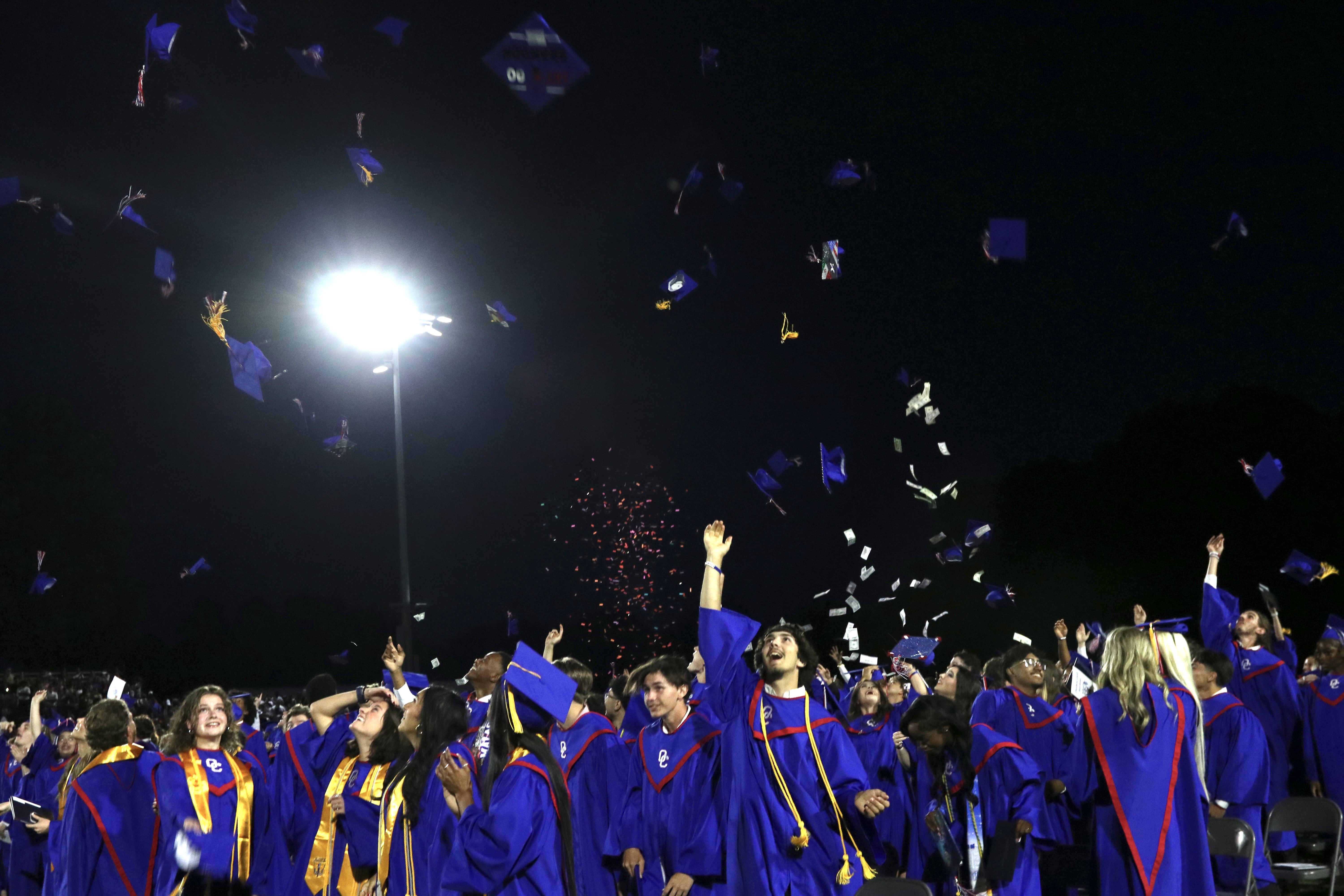 Members of the Oglethorpe County High School class of 2025 toss their caps in the air after receiving their diplomas last Friday at Patriot Stadium. This year’s class included 150 graduates. (Photo/Anna Izquierdo) 