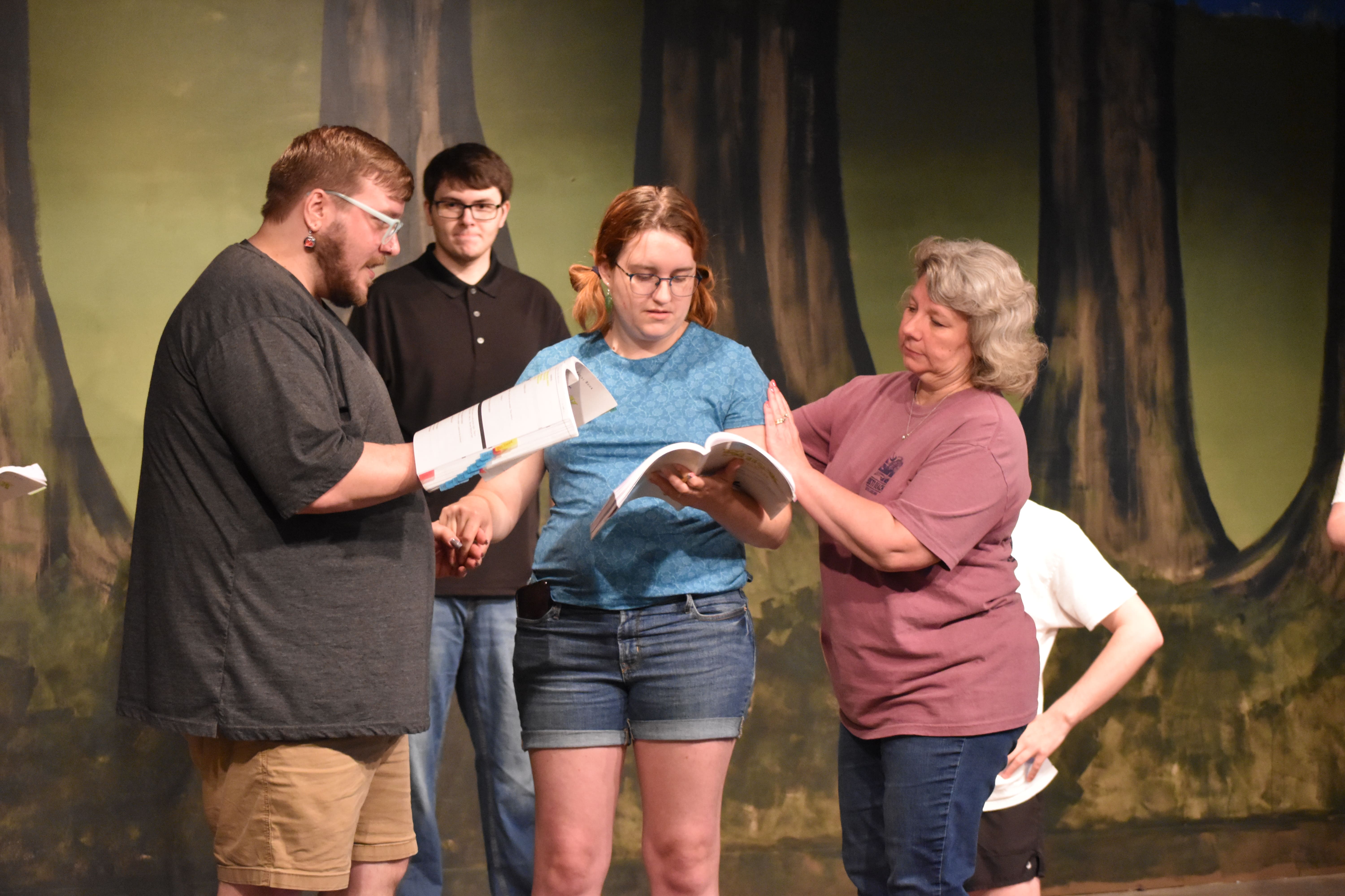 Penny Miller (right), who is directing “Shrek the Musical,” works with Bradley Sullivan (left), who will play Shrek, and Killian Ross (center), who will play Fiona, in a rehearsal at the Historic Crawford School on Monday. The show will close Arts!Oglethorpe’s 30th season. (Photo/Emma Greene)
