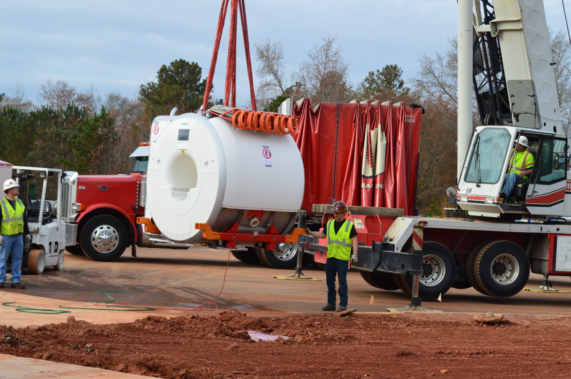 Employees from Atlanta-based architecture firm Perkins & Will help to unload an MRI machine during construction and design of the University of Georgia Veterinary Teaching Hospital, which opened in 2015. Susan Sharp said the process often came with “learning curves,” like determining the amount of space the machines needed. (Submitted Photo)