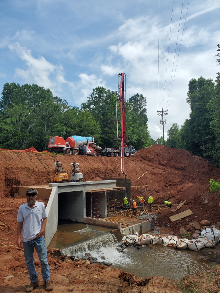 Clint Proffer of High Ground LLC stands in front of the construction on Moss Creek. Proffer, who worked excavation and demolition on the project, partnered with North Georgia Concrete for the culvert rebuild. (Submitted Photo)