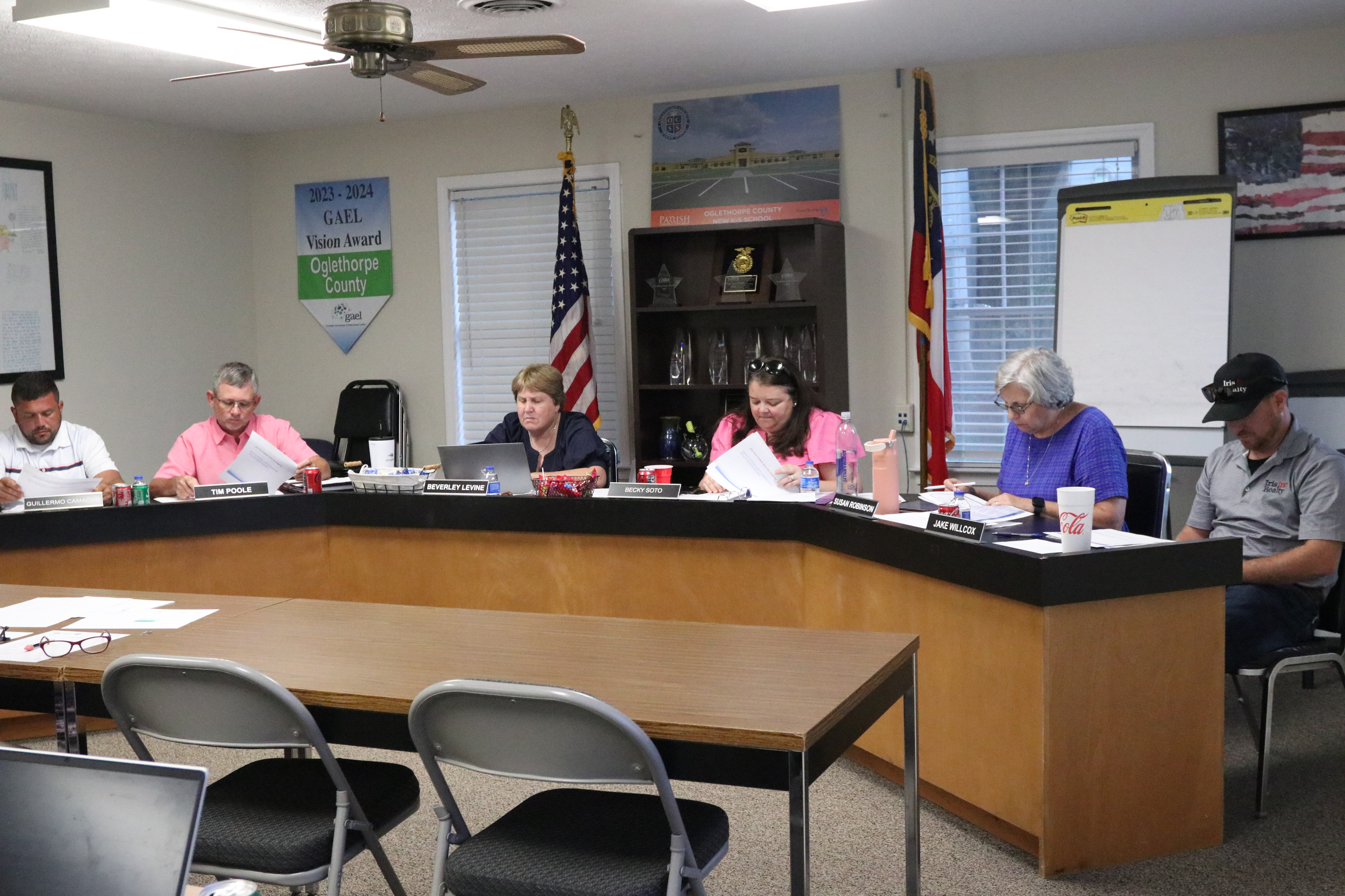 Guillermo Camacho, vice-chair Tim Poole, superintendent Beverley Levine, BOE chair Becky Soto, Susan Robinson and Jake Willcox discuss Shanna Reynolds' request to help fund a full-time extension program assistant on Tuesday. The BOE didn’t take action on the matter. (Photo/Anna Izquierdo)
