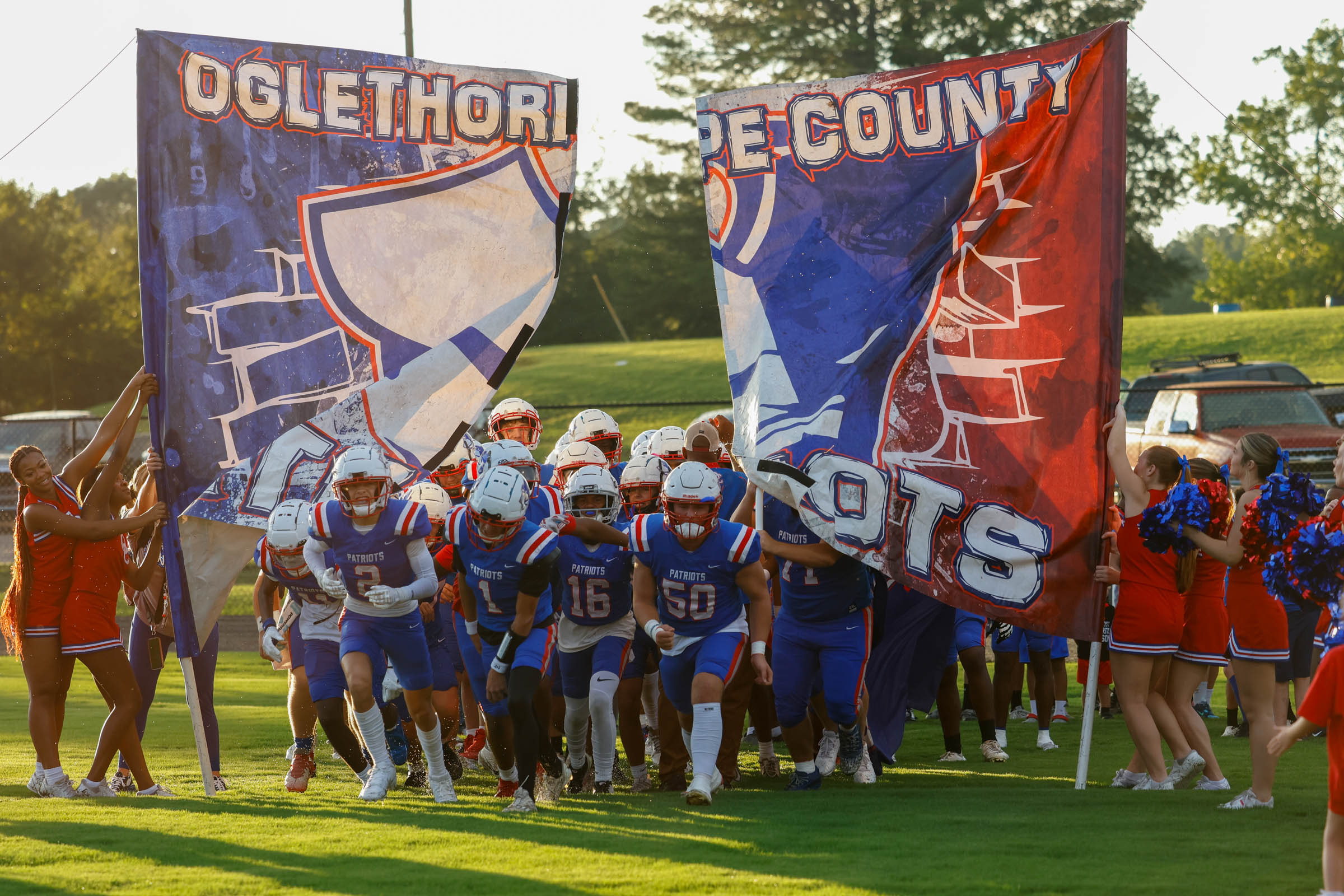 Oglethorpe County High School football players tear through a banner before a game against East Side High School on Satruday, Aug. 23, 2025. (Photo/Caroline Newbern)