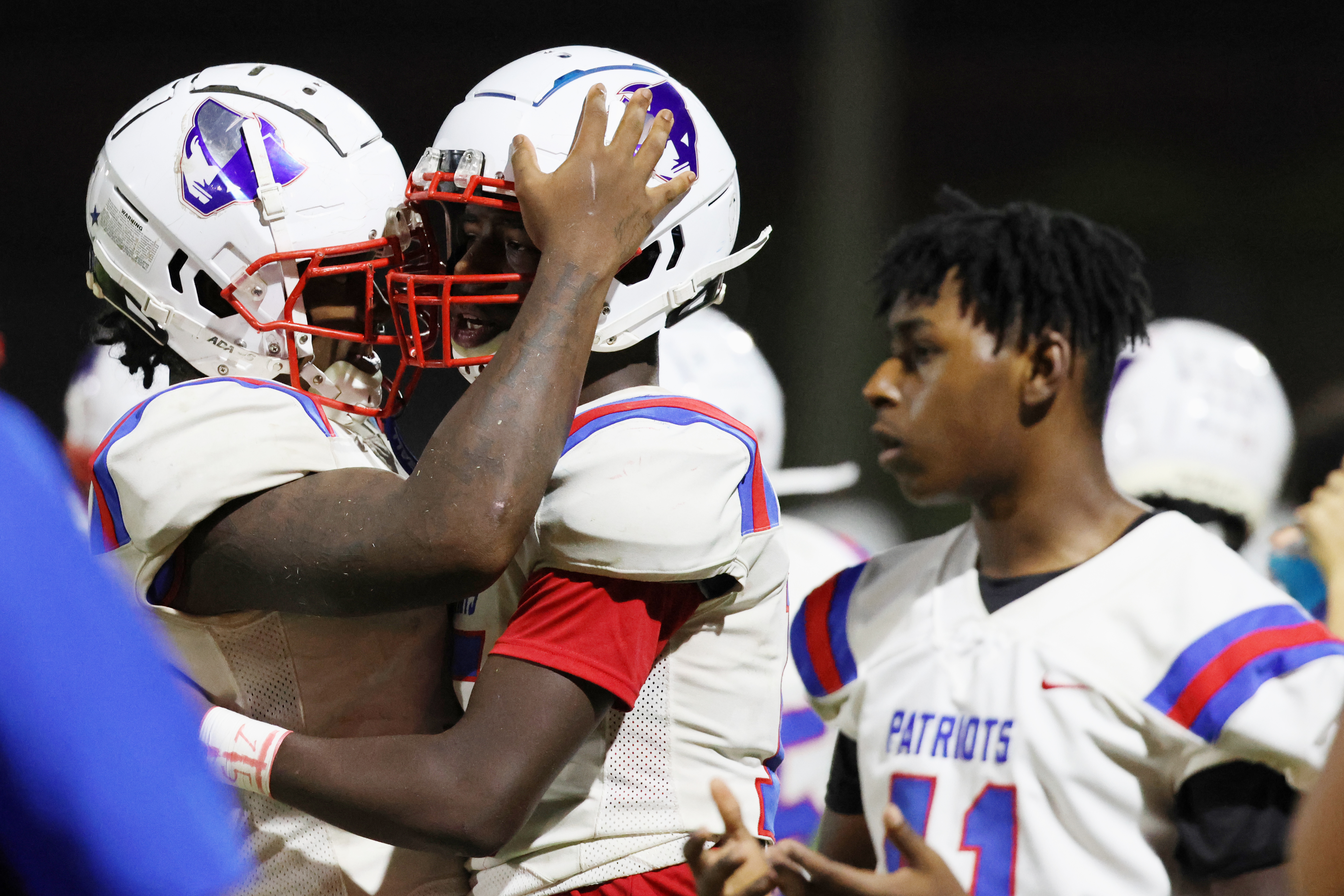 Oglethorpe County High School football players O'Maury Huggs (3) and P.J. Canada (15) hug during a game against Washington Wilkes Comprehensive High School at Tiger Stadium in Washington, Georgia, on Aug. 29, 2025. Oglethorpe County won the game with a score of 42-12. (Photo/Susanna Johnson)