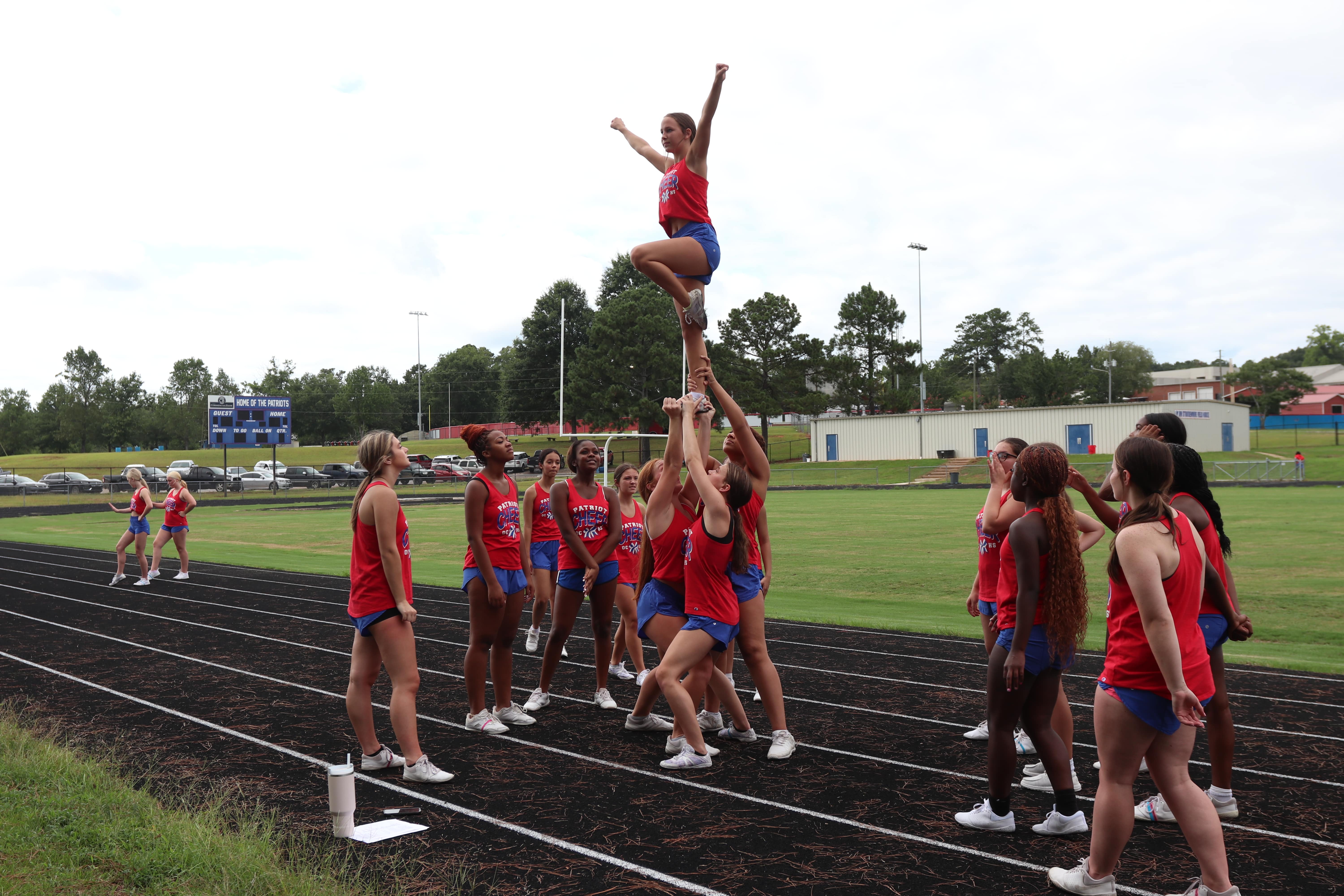The OCHS cheerleaders work on their skills during practice last week. Coach Morgan Williams said 12 girls returned to the team, a majority of them juniors and seniors. (Photo/Anna Izquierdo)