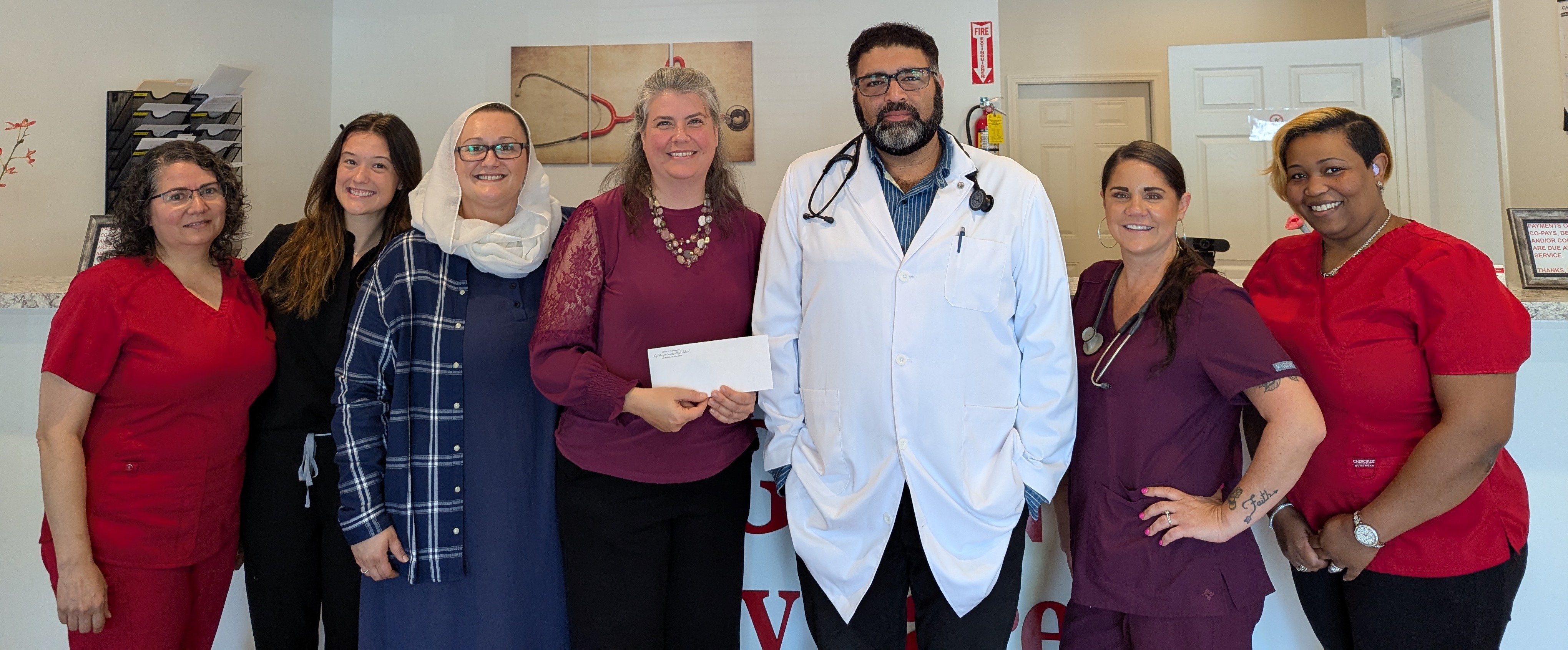 Jennifer Yauck (left) receives a $500 check from Dr. A. Alam Gul of Lexington Primary Care for Oglethorpe County’s Dolly Parton Imagination Library. (Submitted Photo)