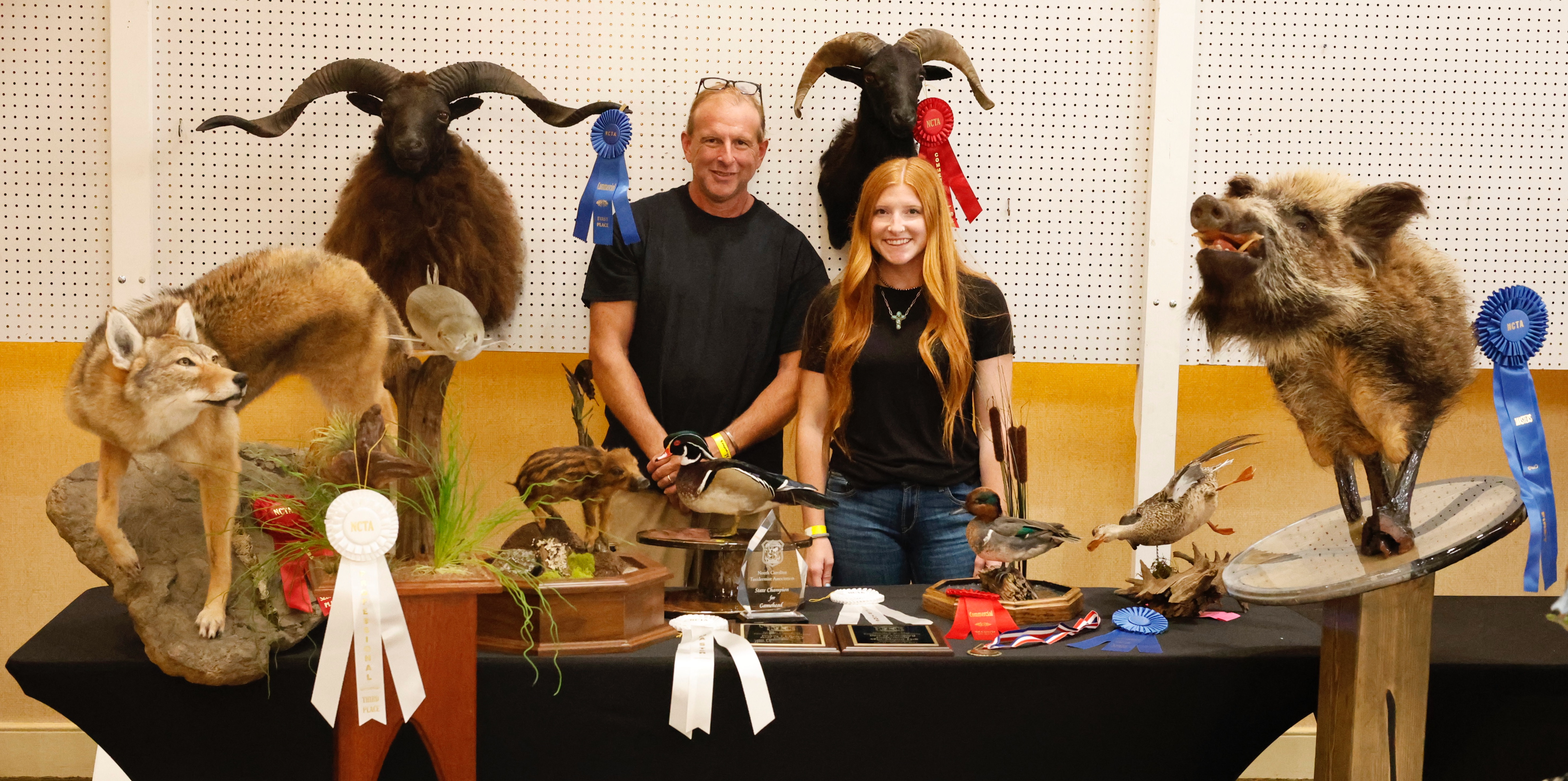 Andy and Madison Nimmons stand with an assortment of their entries at the North Carolina Taxidermist’s Association summer show. They won ribbons and medals for fish, birds and various mammals. (Submitted Photo)