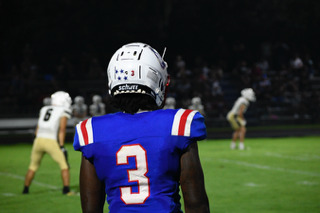 Senior O'Maury Huggs plays in the Patriots’ 30-27 victory over East Hall last Saturday. He played both defensive end and running back in the game. (ANDY MATHIS/THE OGLETHORPE ECHO)