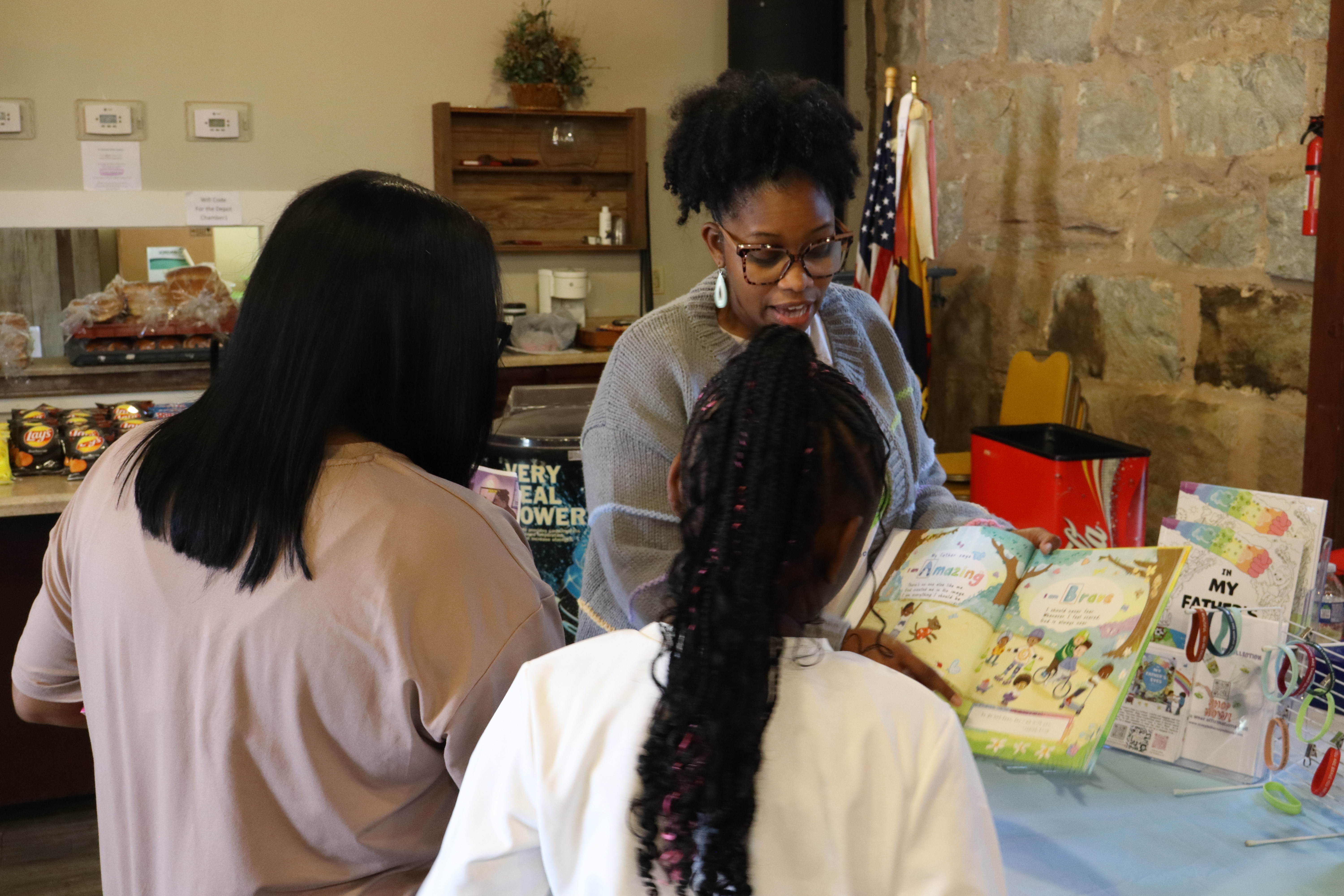 Author Zoe B. Singleton shares her children’s book with attendees at Community Fun and Resource Day on Sept. 13. Singleton emphasizes the importance of affirmation through scripture in her book. (Photo/Molly Moore)