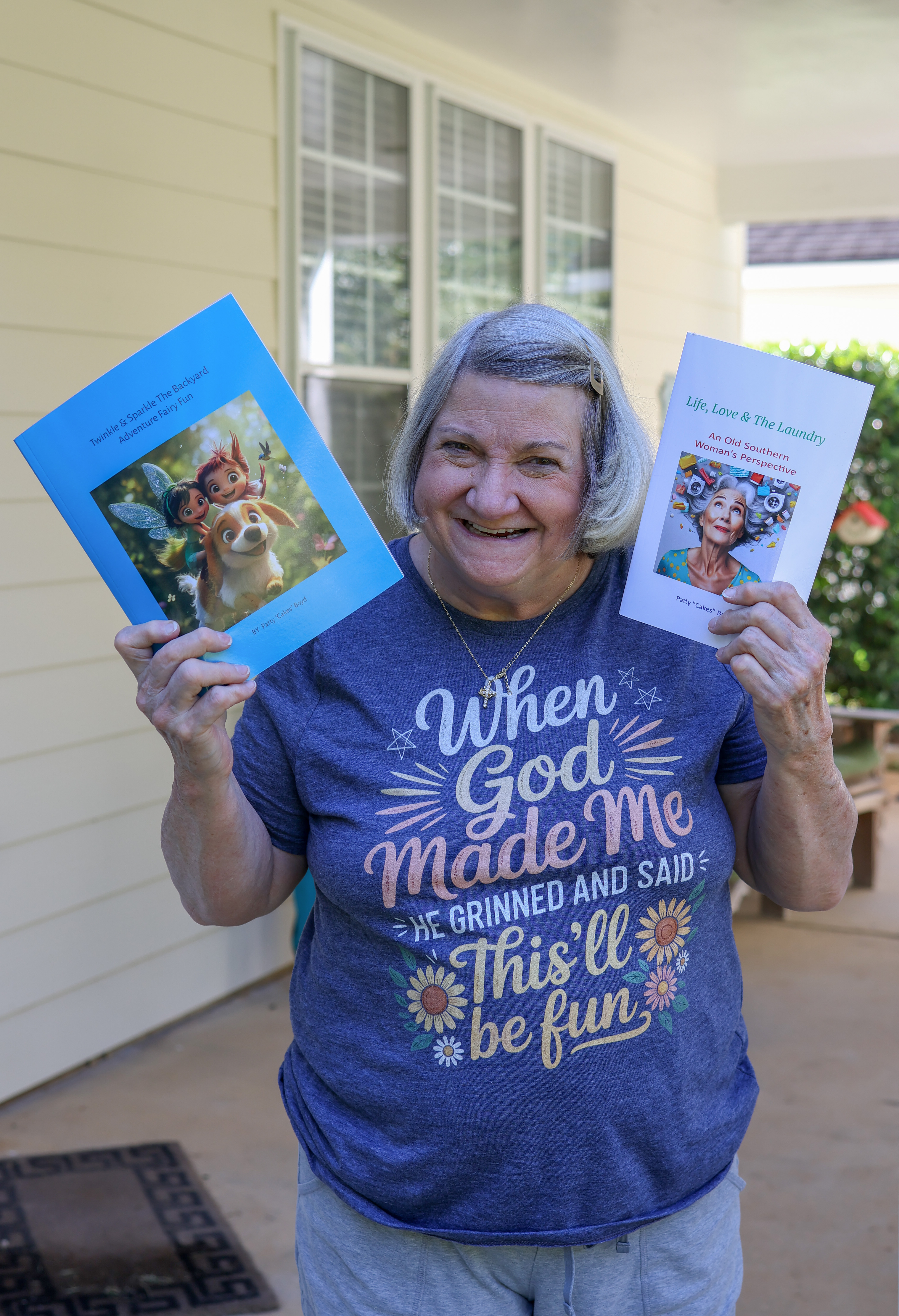 Patty Boyd holds her two new books up for a photo on Sept. 11, 2025 at her home in Colbert. Boyd published "Life, Love & the Laundry" in May and "Twinkle and Sparkle - The Backyard Adventure: Fairy Fun" in July. (Photo/Susanna Johnson)