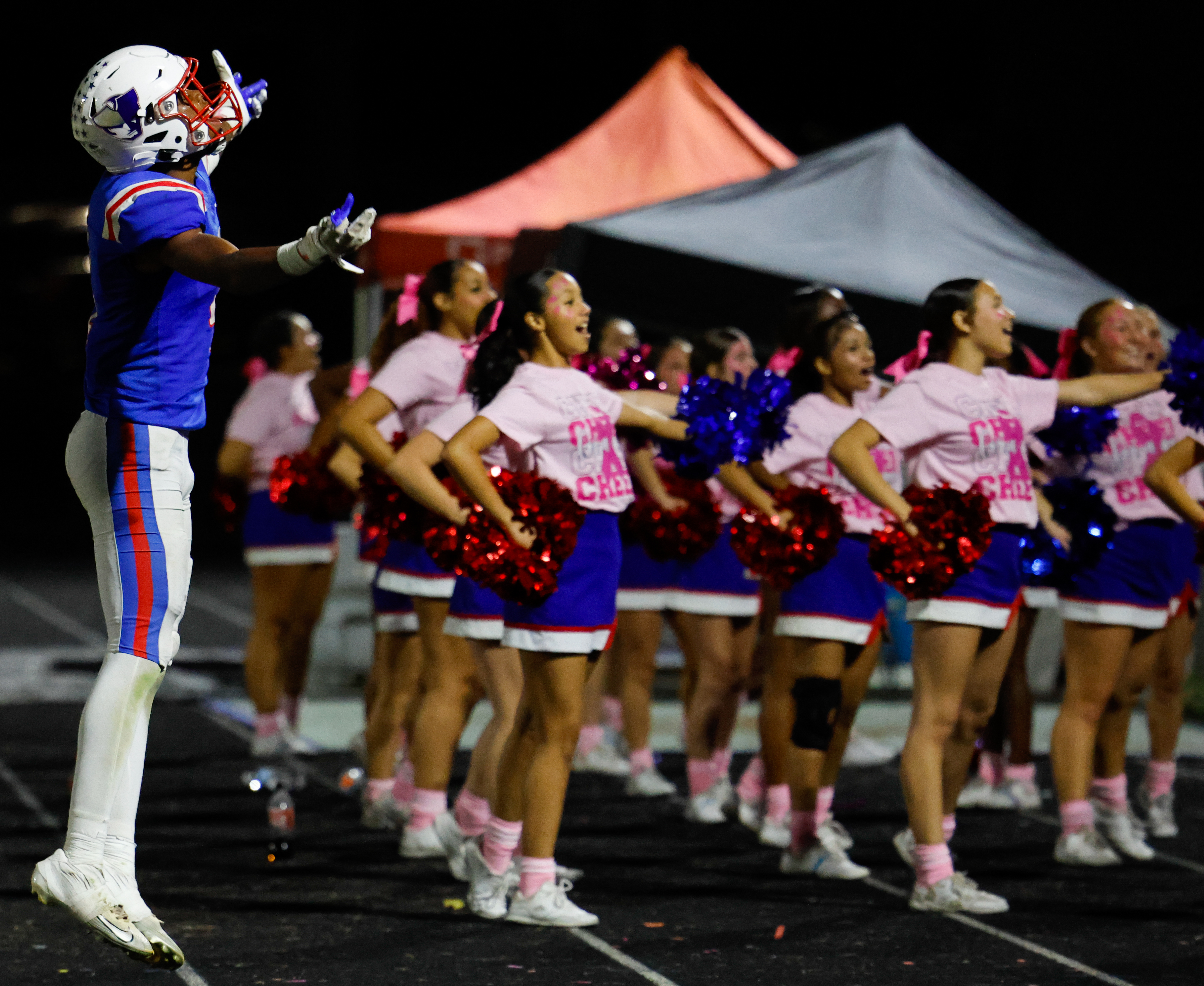 In the fourth quarter of Oglethorpe County High School's game against Rabun County High School, junior Nicah Pass (4) helps the cheerleaders energize the crowd. (Photo/Caroline Newbern)