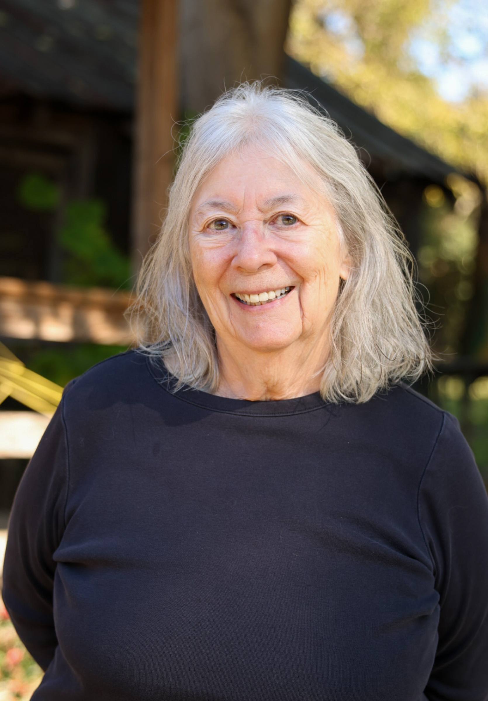 Kathleen deMarrais poses for a photo outside the Rowdy Rooster, which she owns with Jamie Lewis, in Lexington on Nov. 4, 2025. DeMarrais has won the Lifetime Achievement Award from the American Educational Studies Association (AESA), a research organization for educators she has been involved in since the 1980s. (Photo/Susanna Johnson)