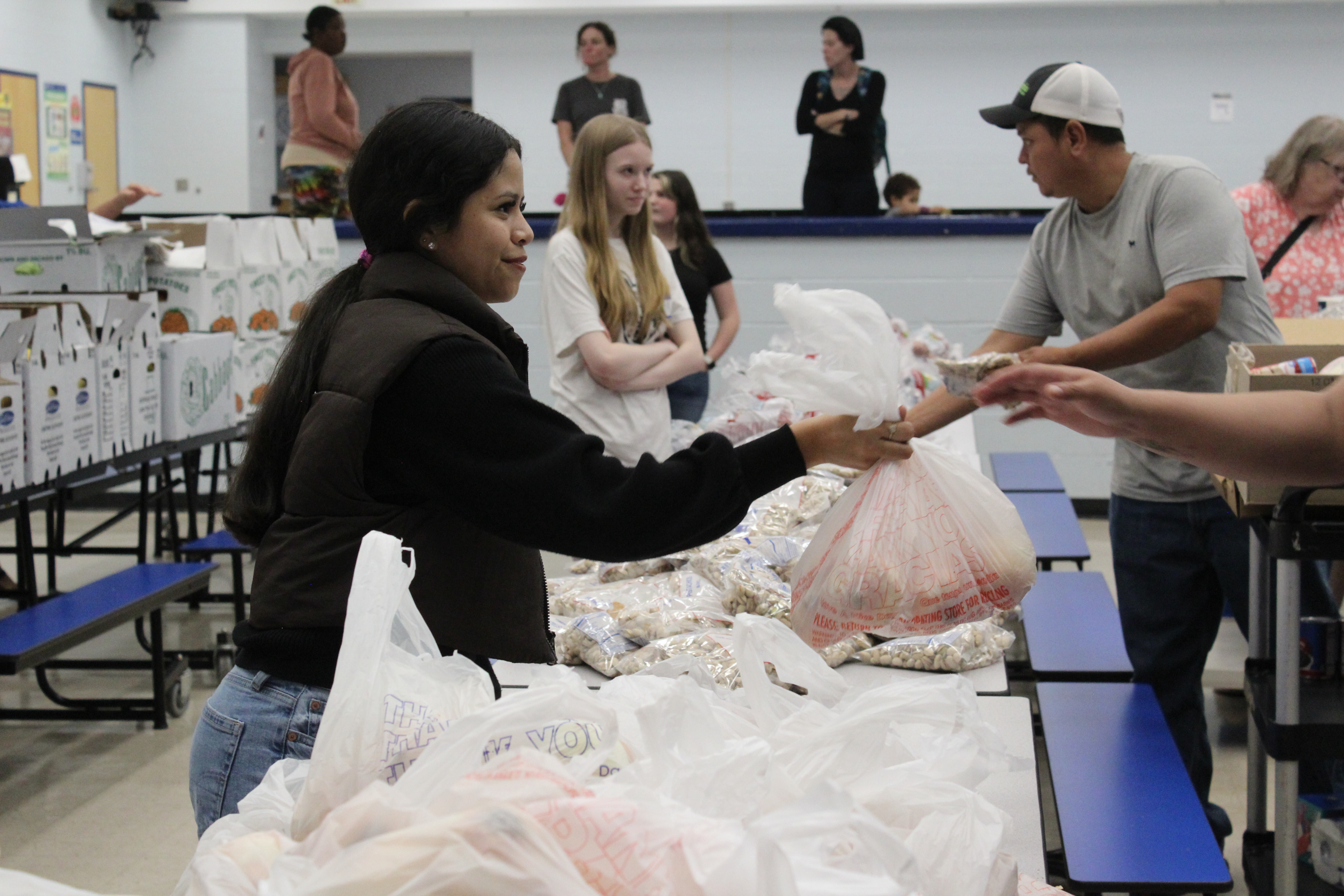 Pricila Salas-Lopez, a junior at OCHS, hands out bags of onions to families at the high school food pantry on Nov. 20. Salas-Lopez began volunteering for the pantry because she loves helping people. (Hannah Freeman/The Oglethorpe Echo)