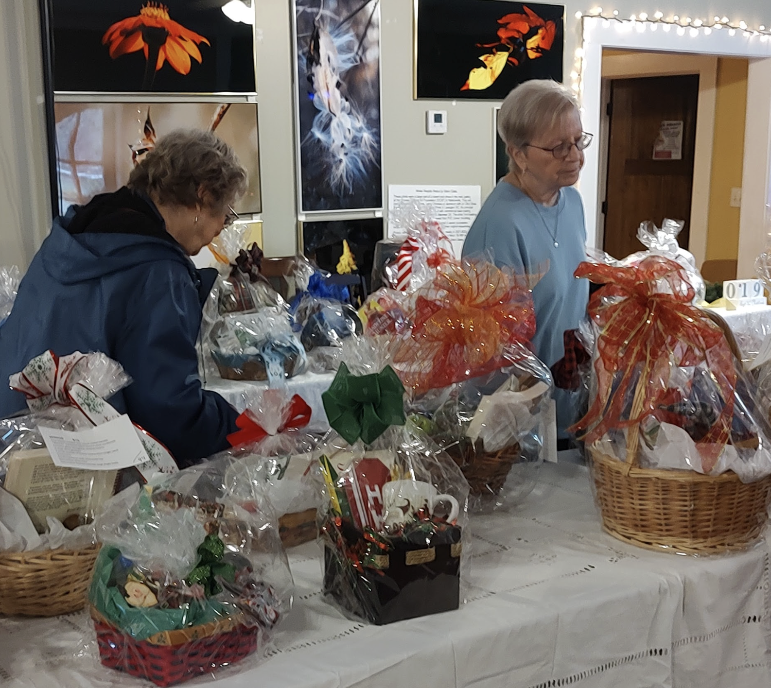 Shoppers look over several of the 100 baskets that were available at the fifth annual Christmas Bazaar and Book Sale on Saturday at No. 3 Railroad St. “We get people coming from all over the county to buy the gift baskets and various things,” said Jean Westmacott, the secretary of the Friends of the Oglethorpe Library. (Submitted Photo)