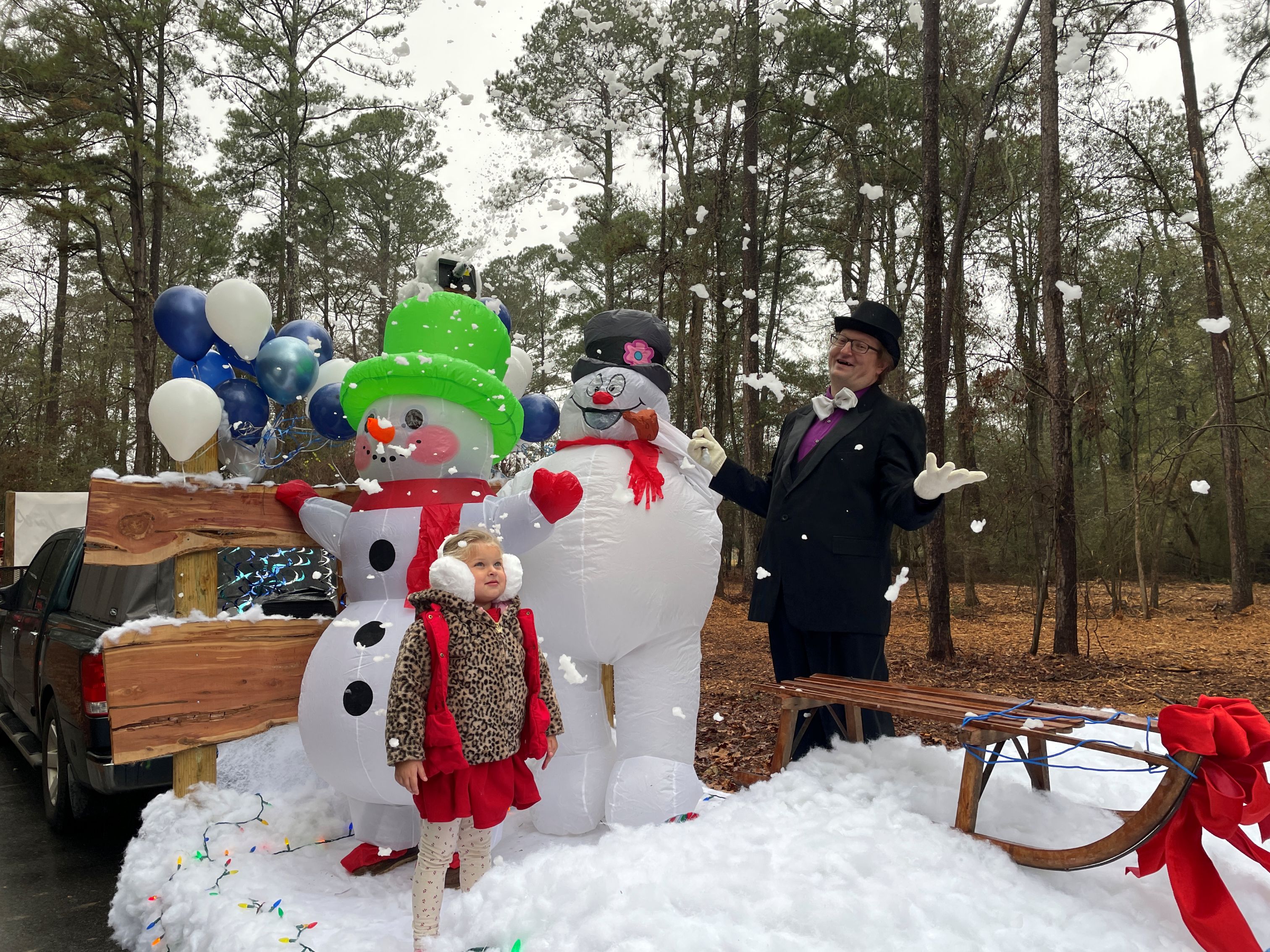 Jeanne Doyle (left) and Daniel Gorman do their part to turn Maxeys into a winter wonderland with their float that featured Danny and Beverly Gorman as Mr. and Mrs. Frosty the Snowman at the seventh annual Maxeys Christmas Parade on Saturday. The Gormans won the award for best float. (Submitted Photo)