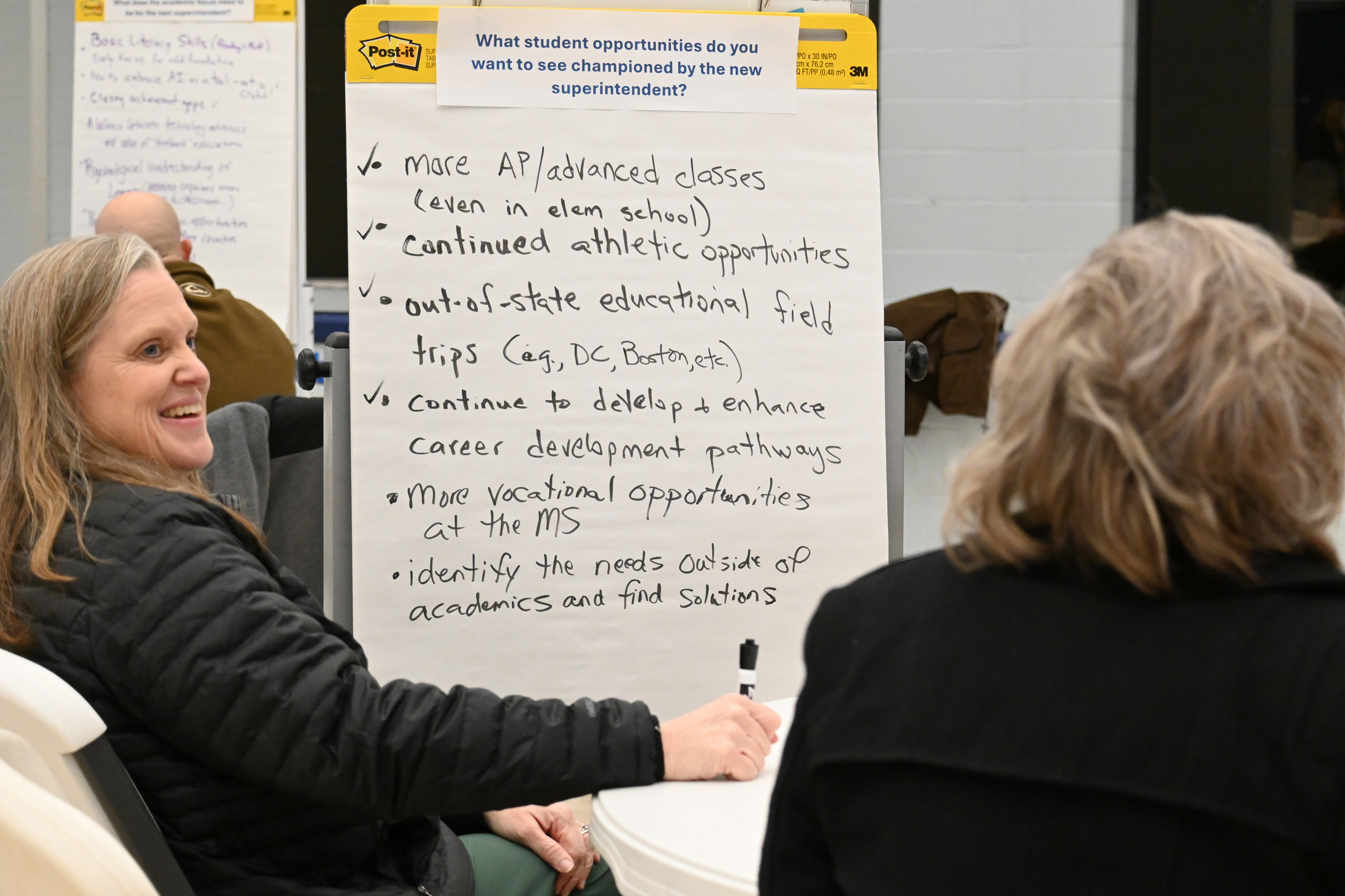 Jill Barnes, a teacher at Oglethorpe County Middle School, takes notes for her group at the superintendent search input session on Jan. 15. Different topics were put at the top of each noteboard for those in attendance to discuss. (Photo/Neva Drane)