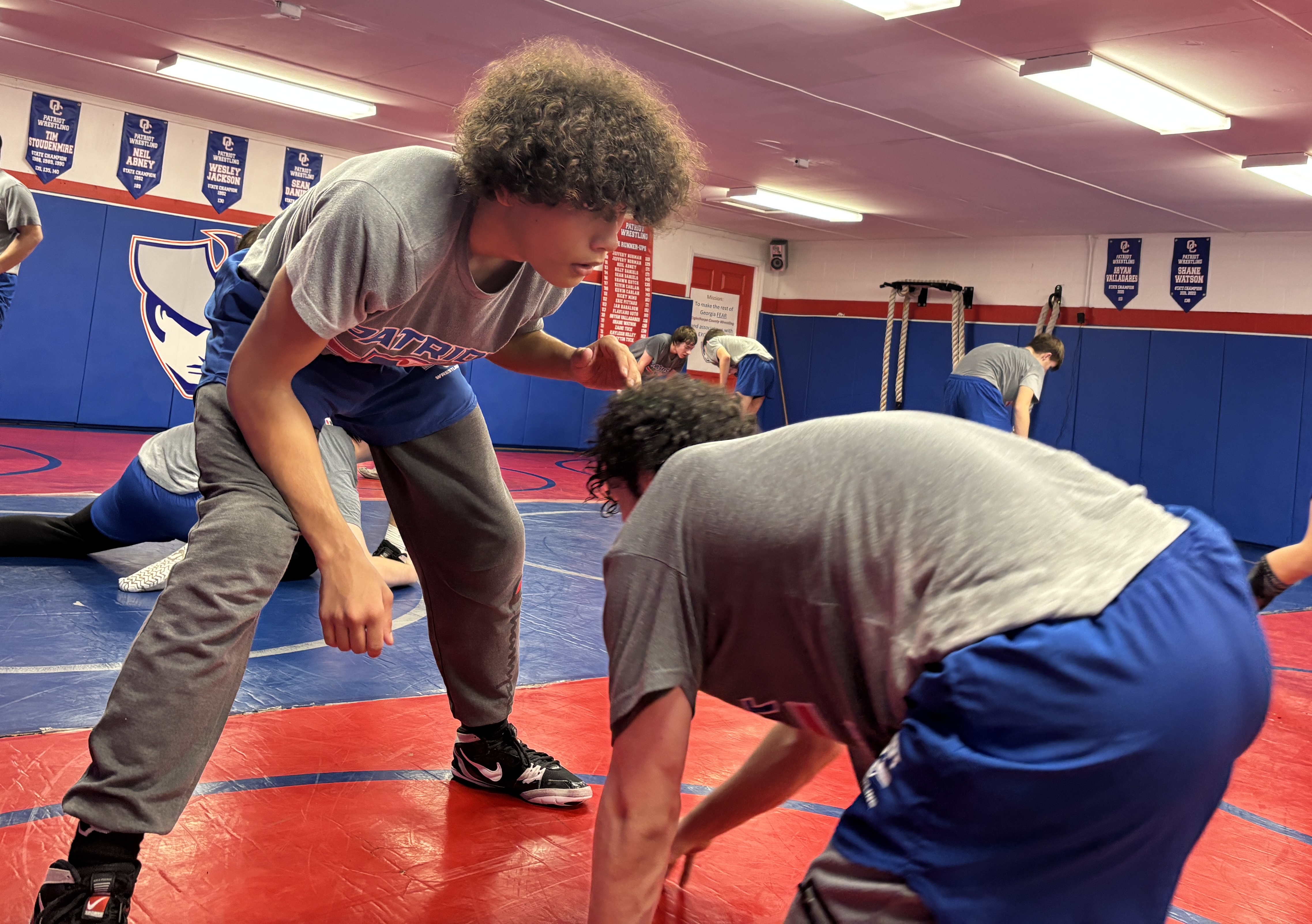 Damien Suarez (left) works on drills with teammate Logan Bruce during the boys wrestling team’s practice on Monday. Suarez is 19-15 at 120 pounds in just his second year wrestling. (Photo/Andy Johnston)