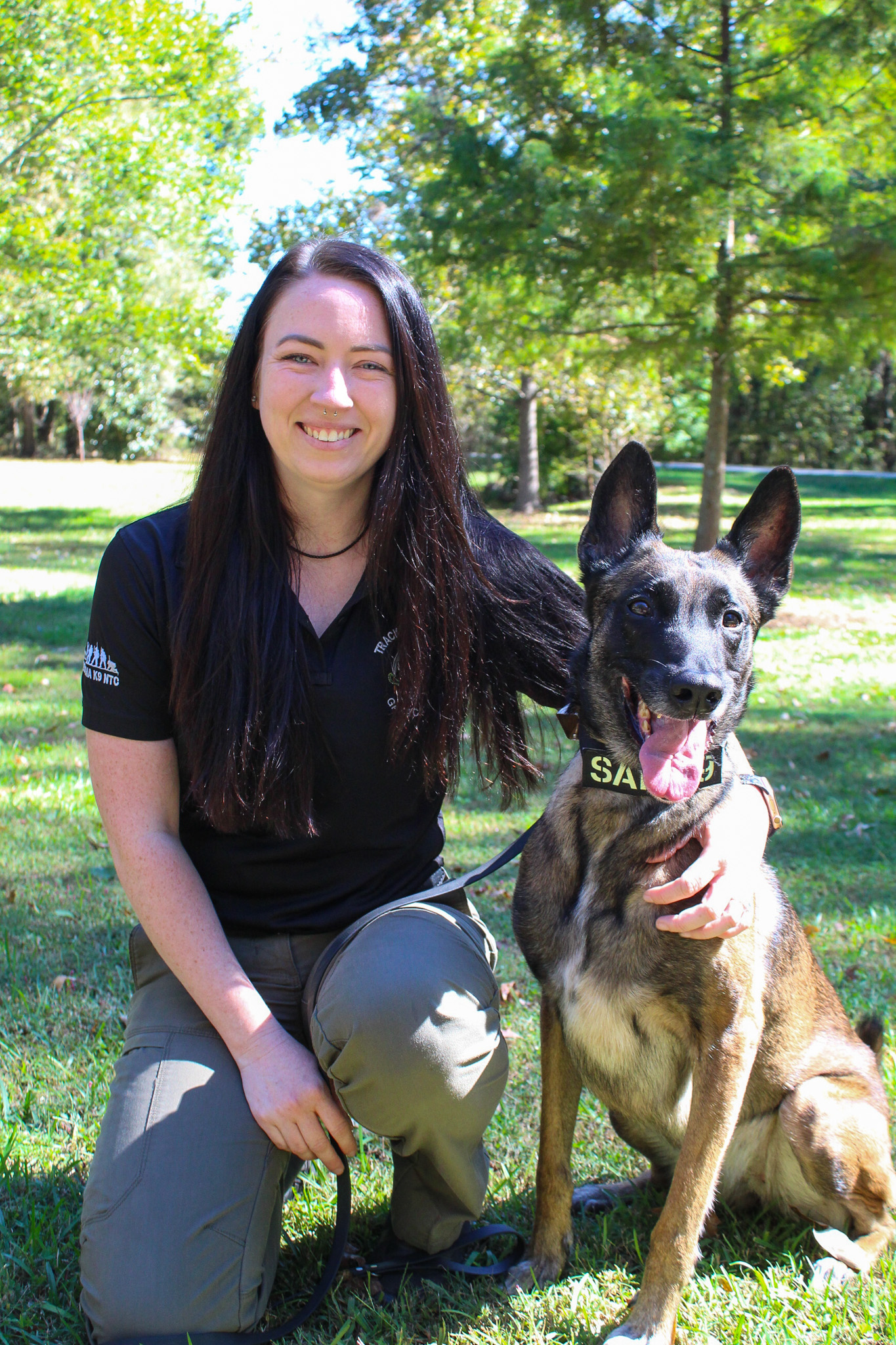 Kristen Moore, a K-9 handler, dog trainer, owner of the Georgia K-9 Athens location and vice president of Central Georgia K-9 Search and Rescue, holds her Belgian Malinois named Carerra at Pittard Park in Winterville this fall. The pair work together in human remains detection and trailing exercises. (Gabrielle Gruszynski/The Oglethorpe Echo)