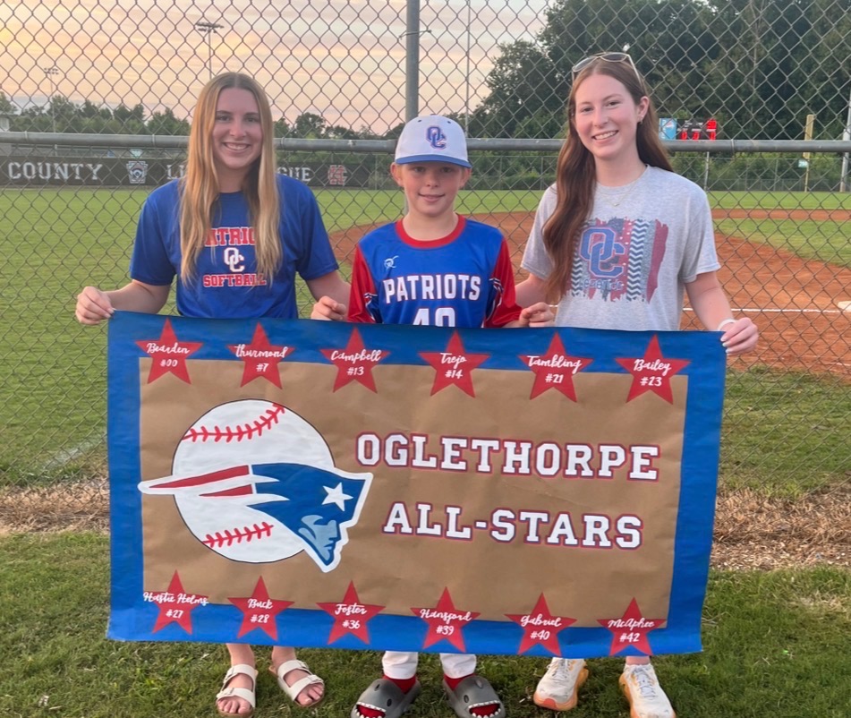 Carlie Gabriel (right), pictured with sister Claire (left) and brother Trey, holds a banner she created for Trey’s all-star baseball team last July. She’s created more than 45 banners for her customers. (Submitted Photo)