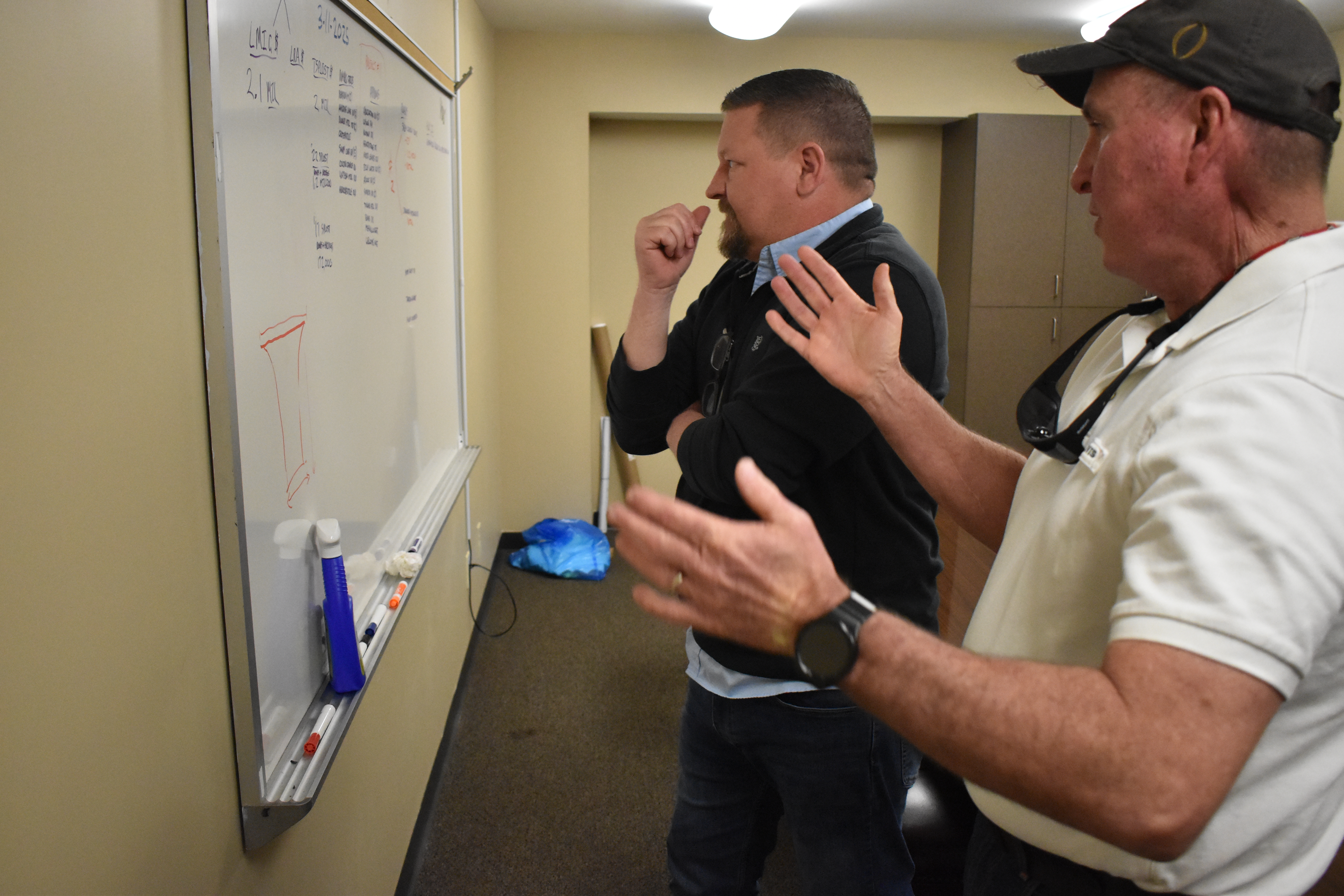 County administrator Jason Lewis (left) and Jeff Sharp, the county’s director of planning, zoning and compliance, discuss a road repair project last year. Lewis said county officials are working to make the government more transparent for residents. (ZACH LEGGIO/THE OGLETHORPE ECHO)