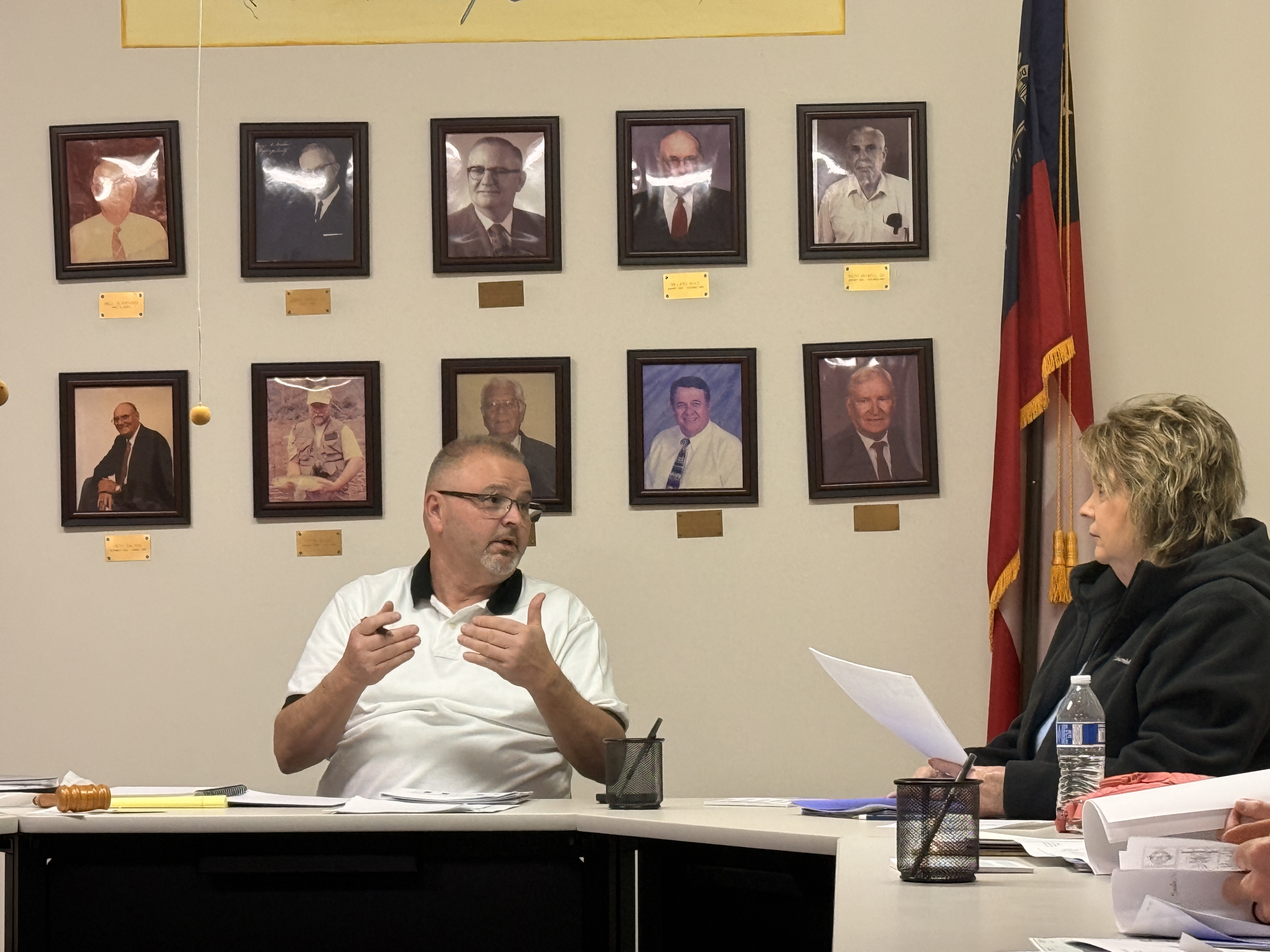 Crawford Mayor Alan Erwin speaks to council member Kathy Little during the Crawford City Council meeting on Feb. 10, gesturing as he addresses council members inside City Hall. (Photo/Riley Baugh)