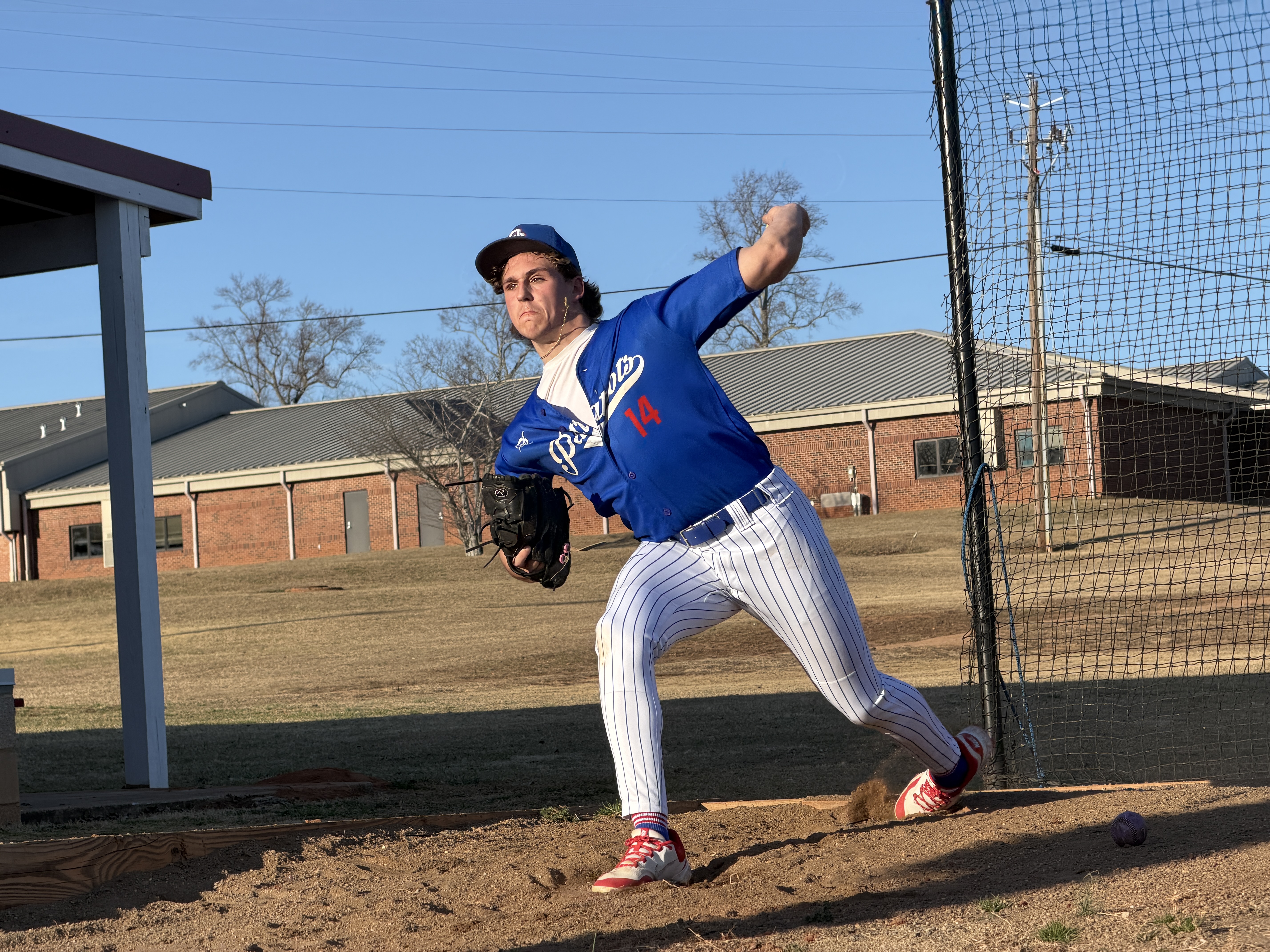 Jackson Tatum warms up in the bullpen before starting against Georgia School for Innovation and the Classics (GSIC) at TY Harris Field on Feb. 12. The Patriots won 10-0 behind Tatum, who struck out six in five innings. (Photo/Nicholas Eriksen)