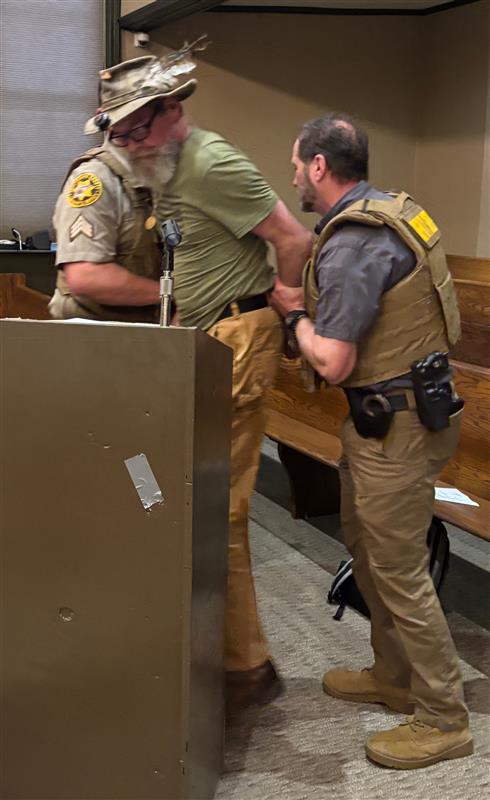 Oglethorpe County deputies detain Brad Johns near the end of the Board of Commissioners meeting at the courthouse on Monday. Johns was booked on three charges, including public intoxication. (Andy Johnston/The Oglethorpe Echo)