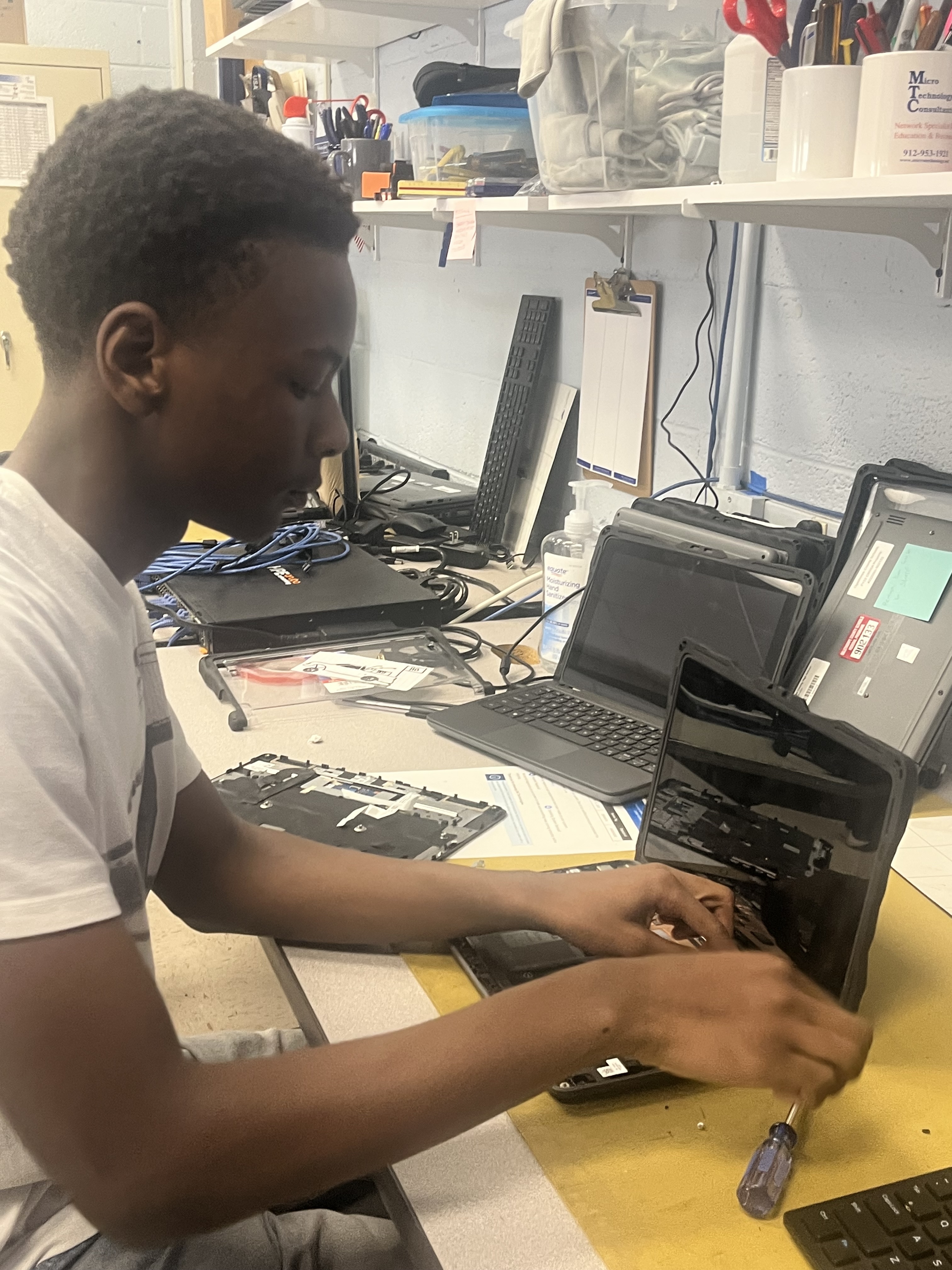 Victor Ross works repairing the keyboard on a school laptop during his internship in the Oglethorpe County High School's IT department after school on Feb. 12, 2026. He usually works during his seventh period, and this internship has helped him see himself in a computer science-related career. (Photo/Eva Saraf)