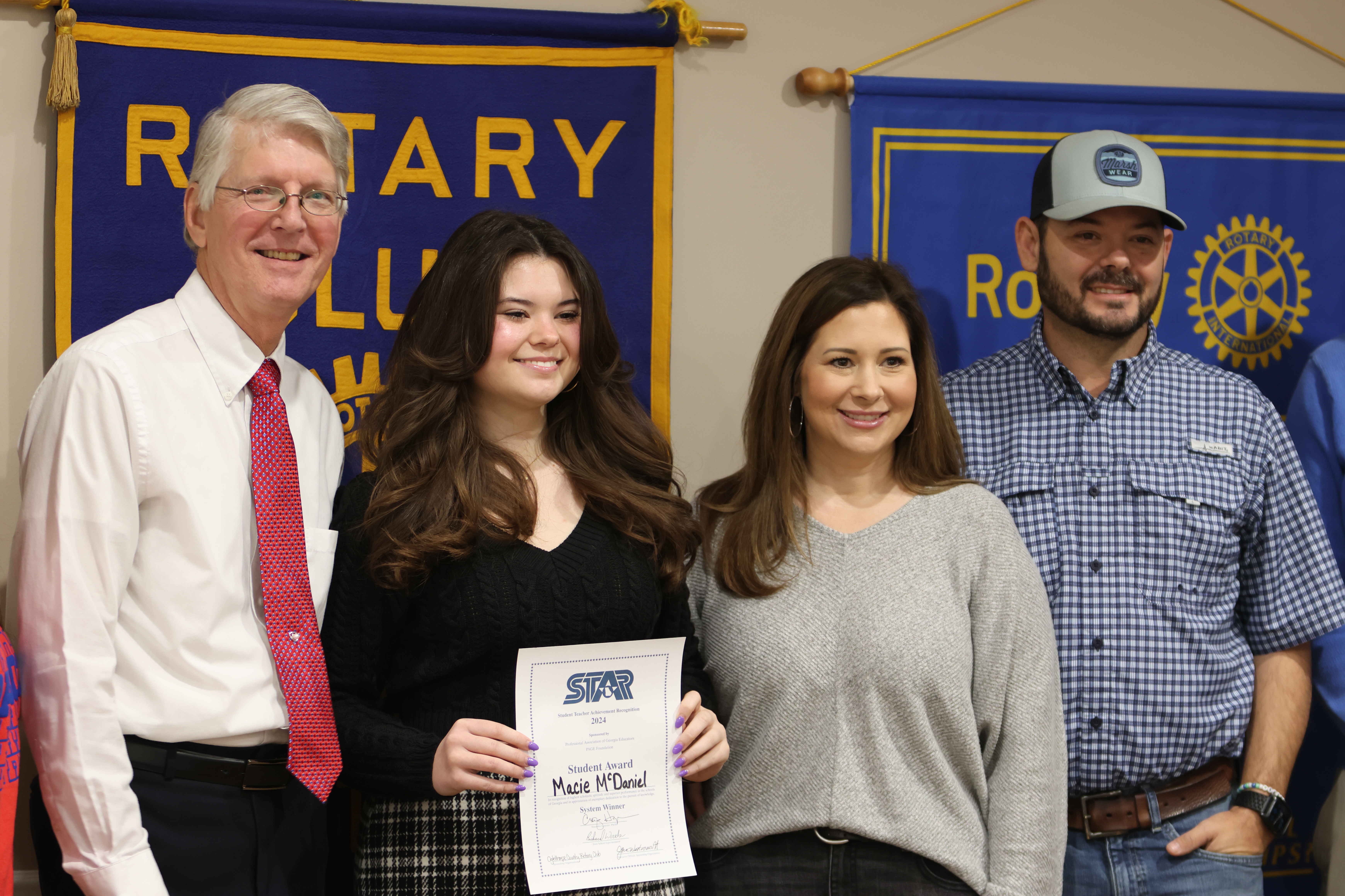 Macie McDaniel received a certificate for being named Oglethorpe County High’s STAR student at a Rotary Club meeting in February 2024. She was honored with 2024 STAR teacher Eric Schmidt (from left), Christan McDaniel and Phillip McDaniel, her mom and dad. (JIM BASS/THE OGLETHORPE ECHO)