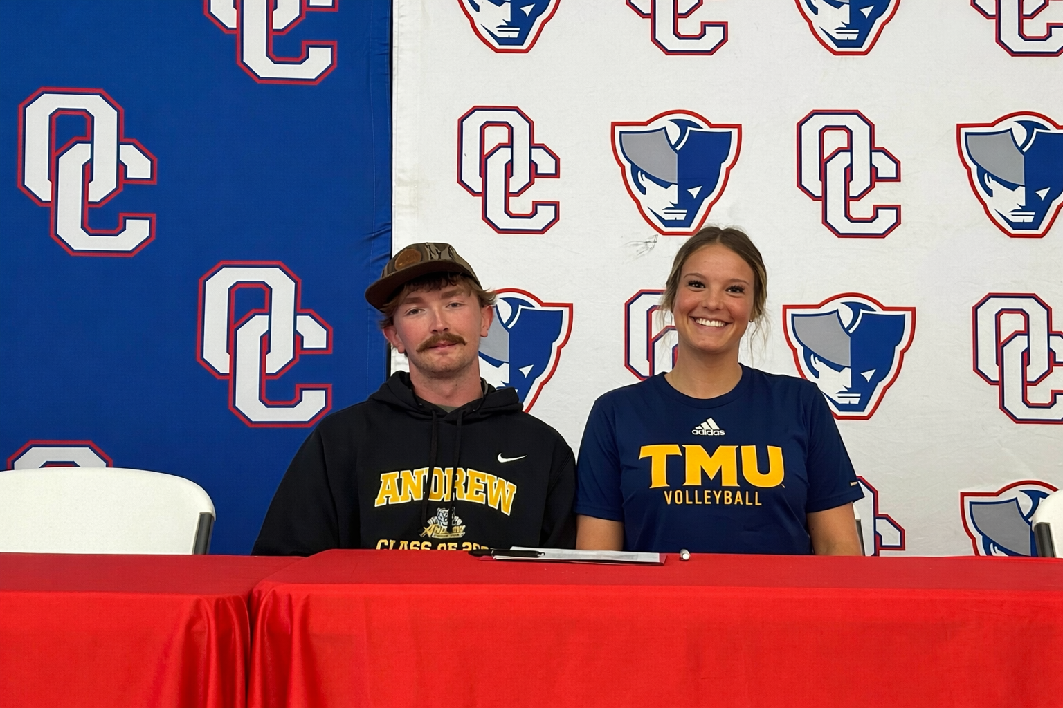 Cousins and OCHS athletes Tripp White and Elizabeth Cook show their college colors during White’s signing day on April 9. White, a pitcher, will play for Andrew College and Cook, a volleyball player, has signed to play at Truett McConnell. (Submitted Photo)