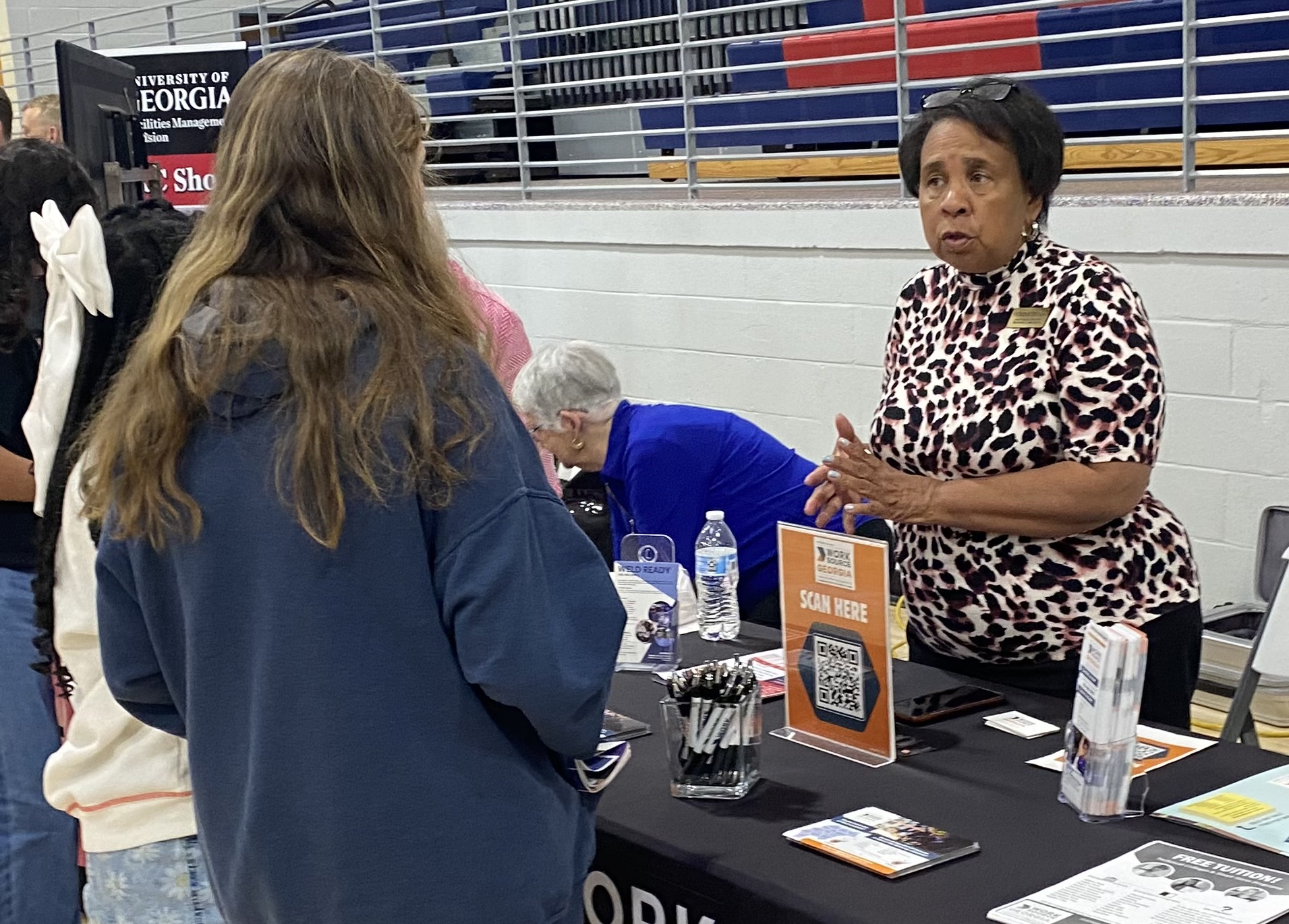 A student talks to someone from WorkSource Atlanta at the Career and Connections Fair at the OCHS gym on Tuesday. Students are allowed to visit a variety of job booths that showcase possible future employment opportunities. (Photo/Ronnie Boggs)