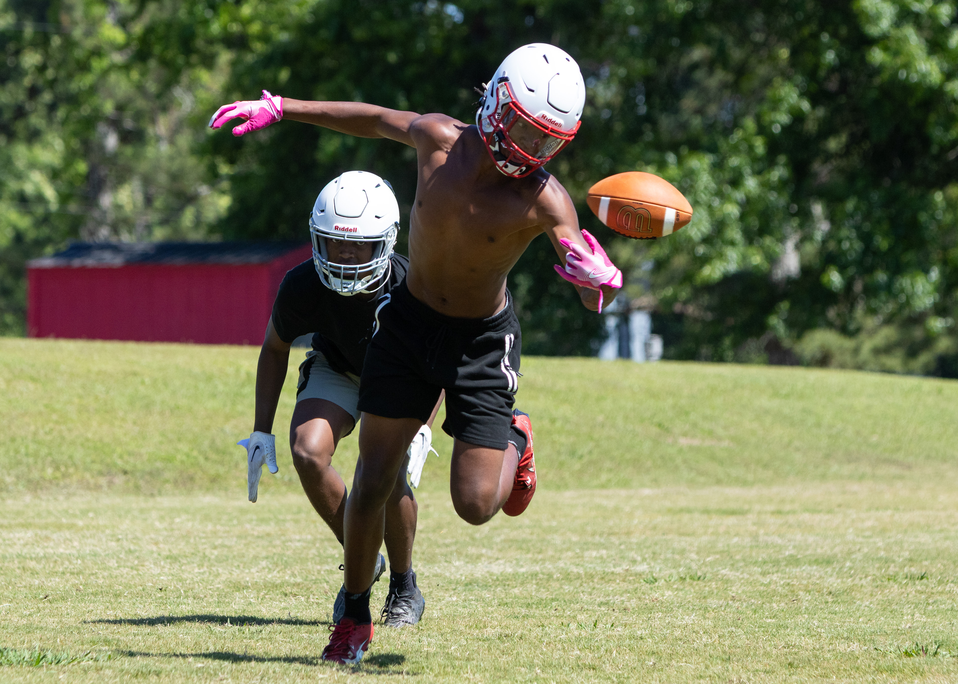 Defensive back Nicah Pass reaches for the ball during football practice on May 15. Pass, a senior, plays alongside his brother, Zion, a sophomore. (Ethan Greene/The Oglethorpe Echo)