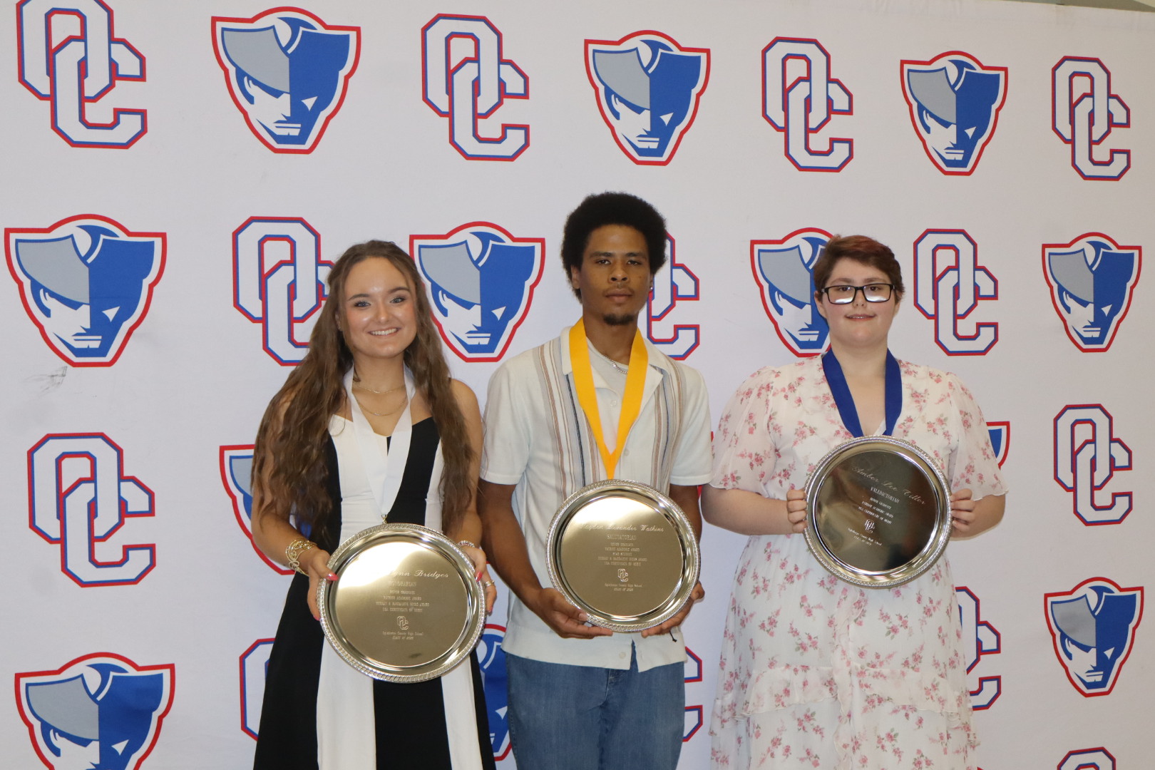 Callie Bridges (from left), the honorian, Kayden Watkins, the salutatorian, and Amber Tiller, the valedictorian, received trophies for their academic achievements at Oglethorpe County’s Senior Honors Night on Tuesday. (Ellie English/The Oglethorpe Echo)