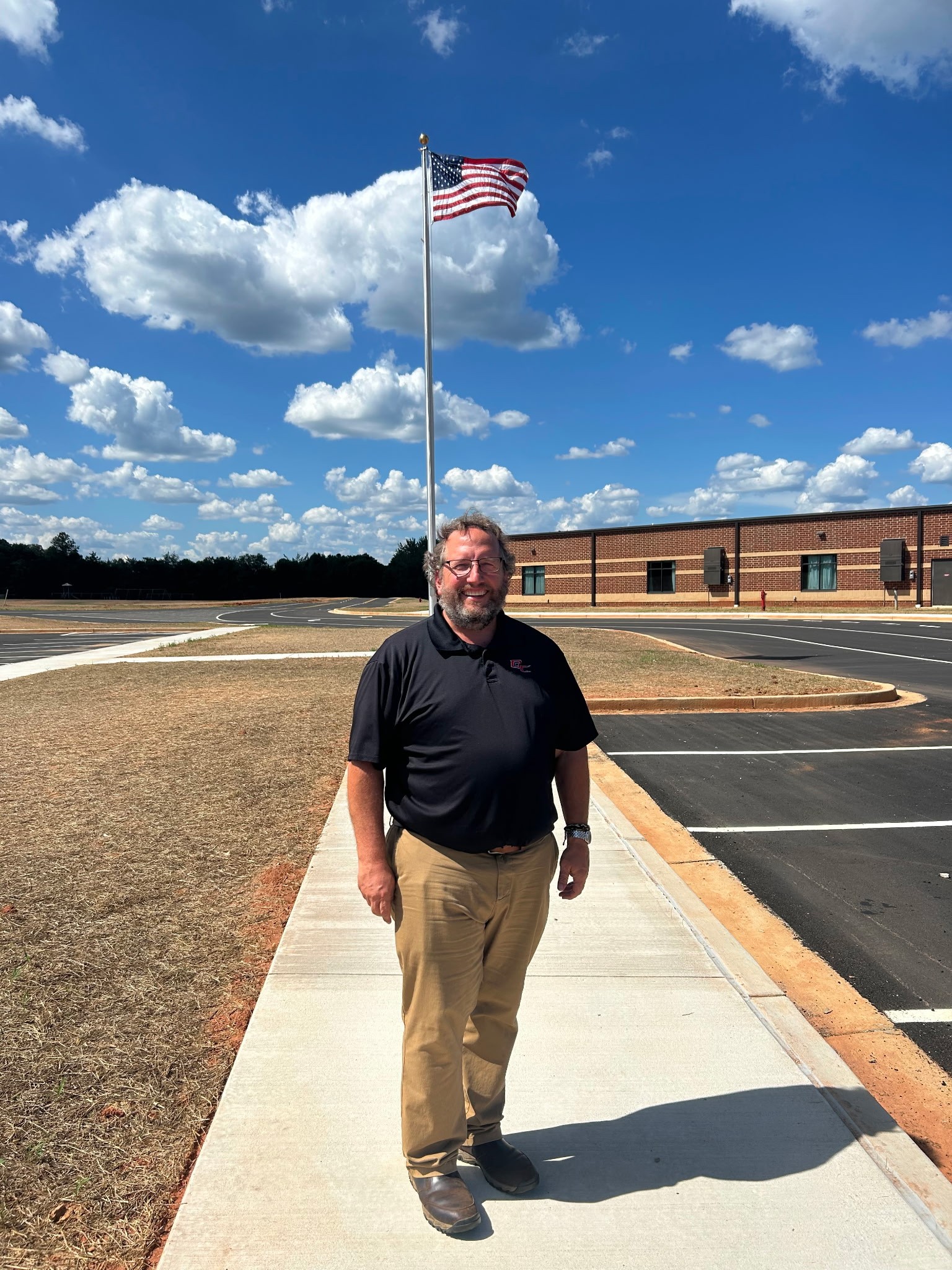 Paul Thiel, operations director for Oglethorpe County Schools, stands in front of the newly constructed Oglethorpe County Elementary School during the ribbon-cutting ceremony on July 27, 2025. After 22 years in Oglethorpe County, and 28 years in education, Thiel is retiring. (Submitted Photo)