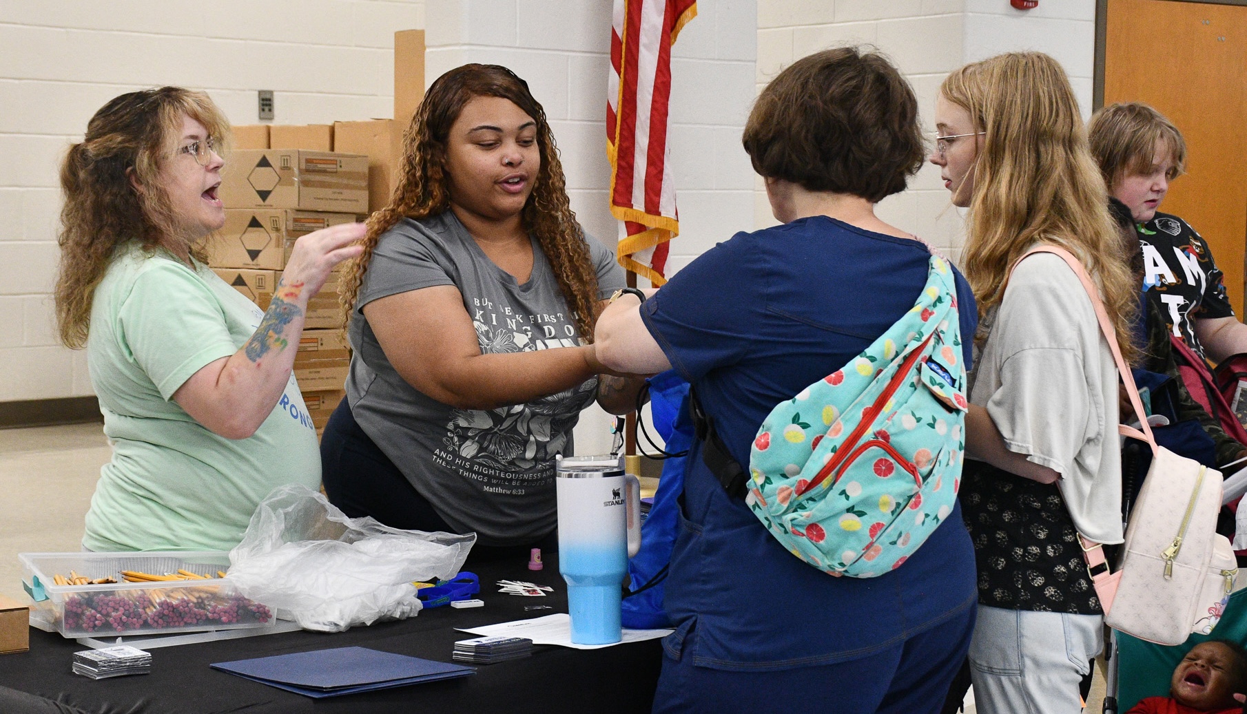MedLink’s Trish Whatley (left) and Desiree Davis (right) pass out goodie bags to families at Community Day at Oglethorpe County Middle School last August. This year’s Community Day will be held on Aug. 8. (Jennifer Xia/The Oglethorpe Echo)