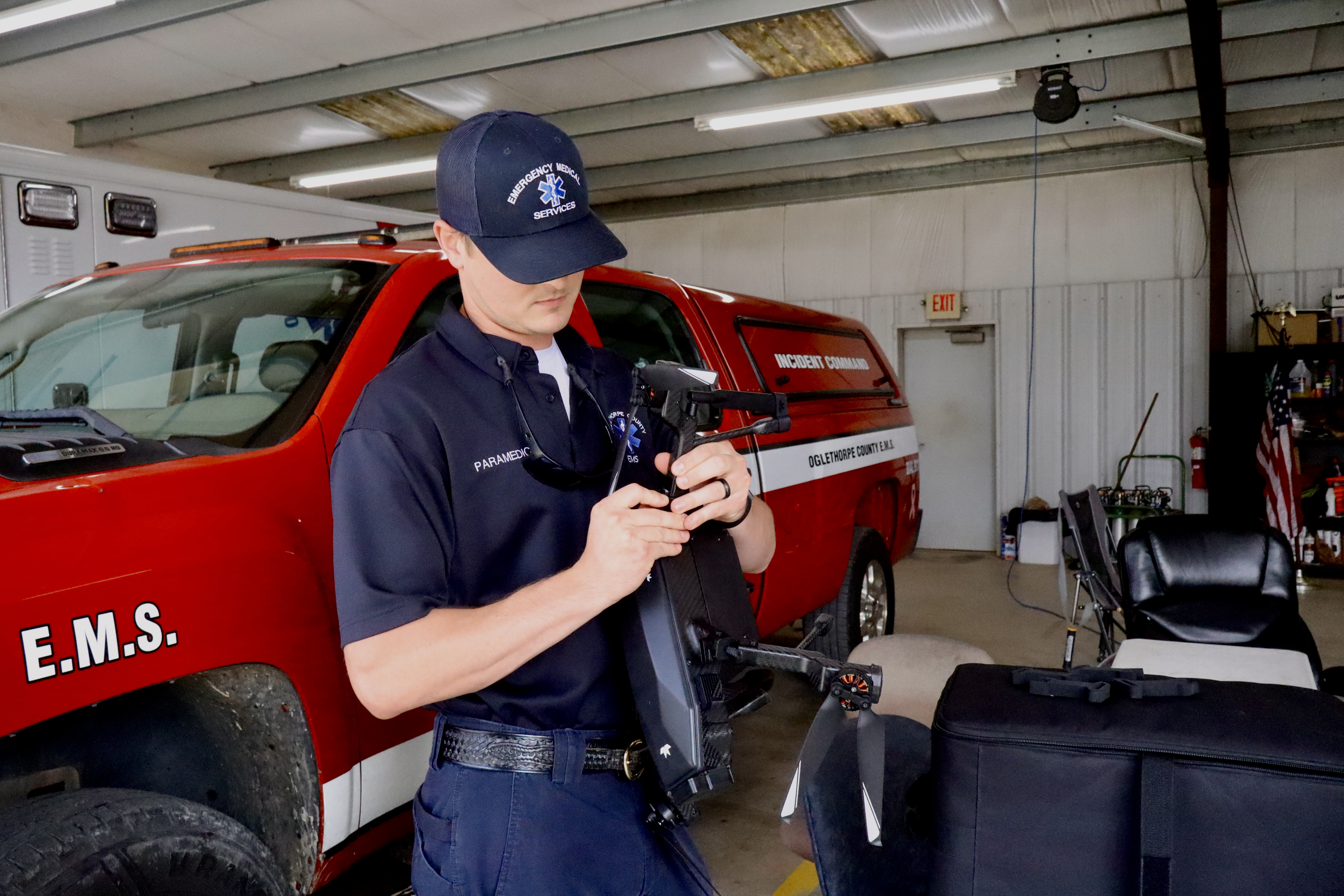 Oglethorpe County EMS shift supervisor and paramedic Dylan Smith assembles a search-and-rescue drone at the EMS station in Crawford on Aug. 29. Smith and local emergency crews work alongside UGA disaster management researchers to integrate advanced aerial technology into rural operations. (ISABELLA PANG/THE OGLETHORPE ECHO)