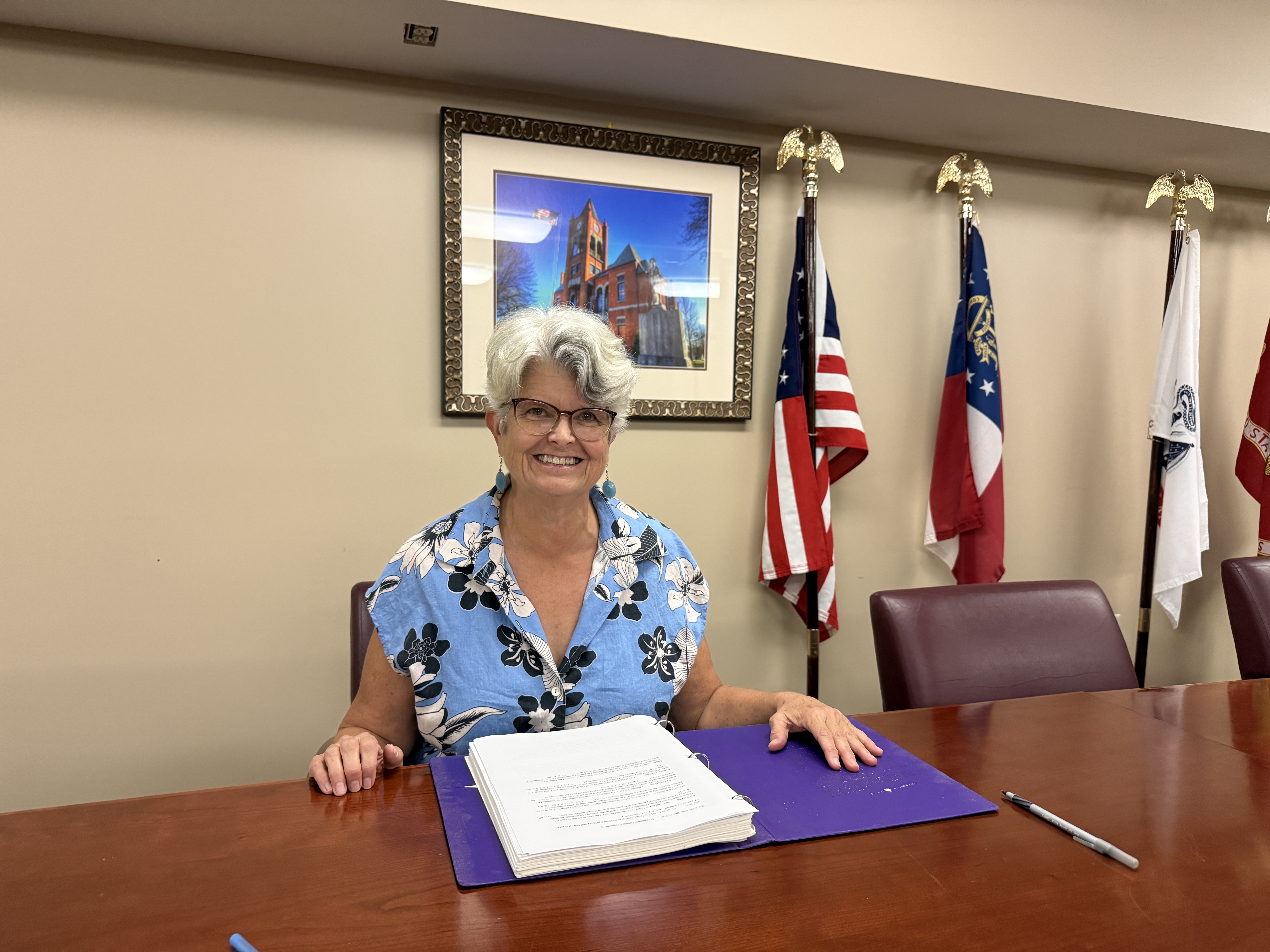 Janet Hill sits and smiles in her seat at the zoning board table on Oct. 2, 2026. Hill retired from work in Athens as an employment lawyer and is now leaving the board as well. (Photo/Ren Grimsley)